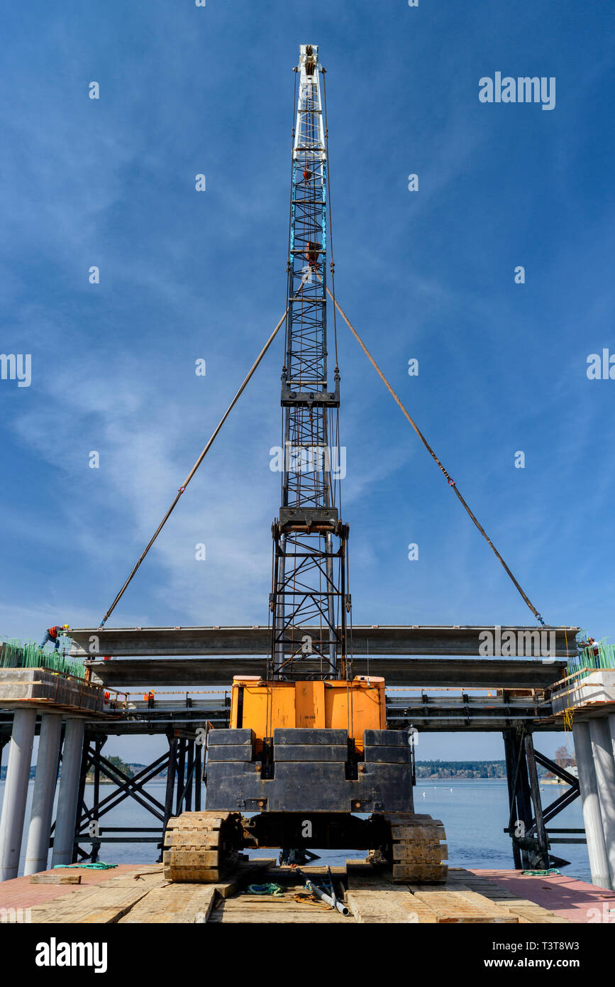 Low angle view of crane and bridge construction Stock Photo - Alamy