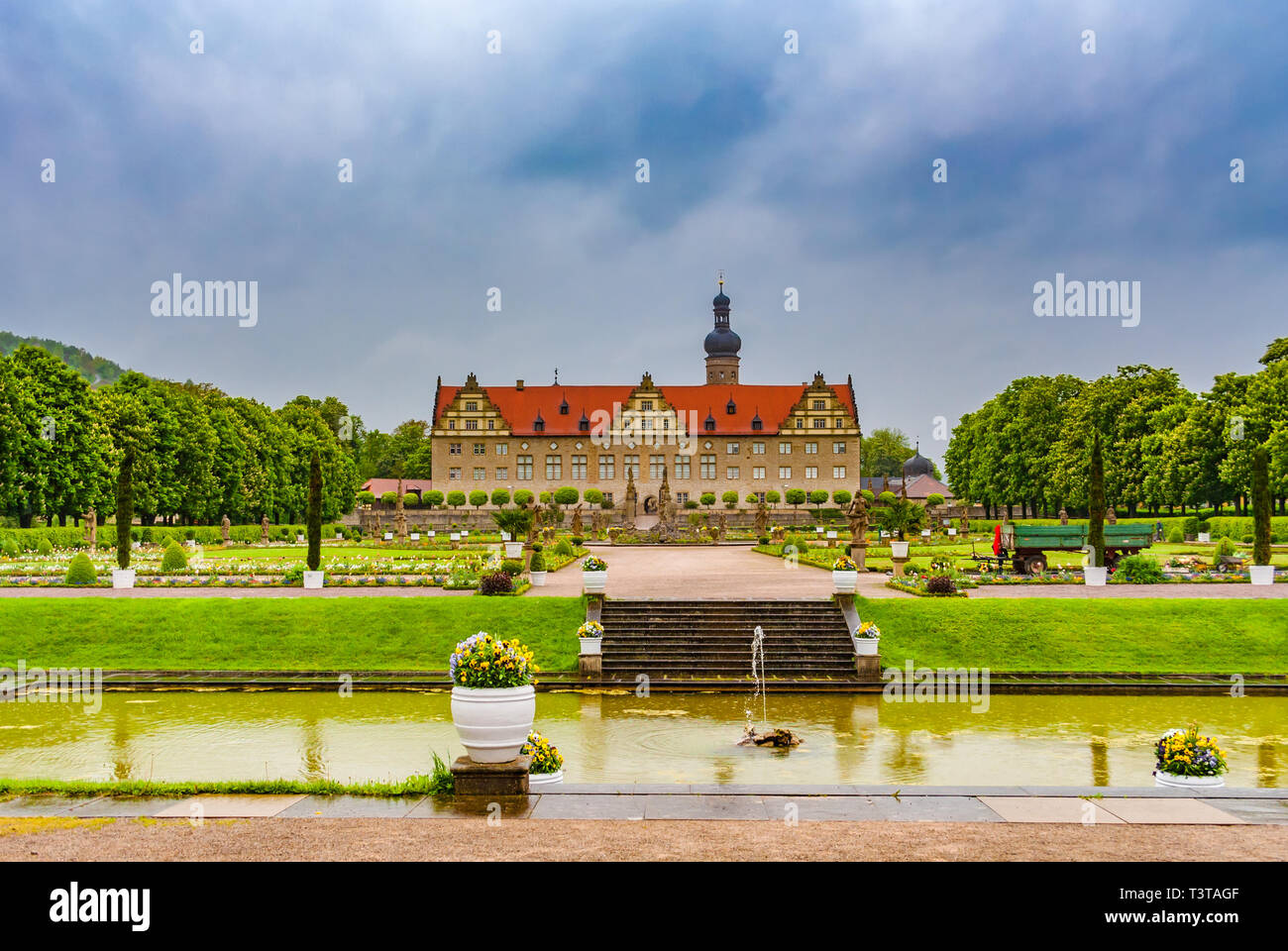 Nice panoramic view of the famous Weikersheim Palace from the pond of the Baroque garden on a cloudy day in Germany. The landmark was the traditional... Stock Photo