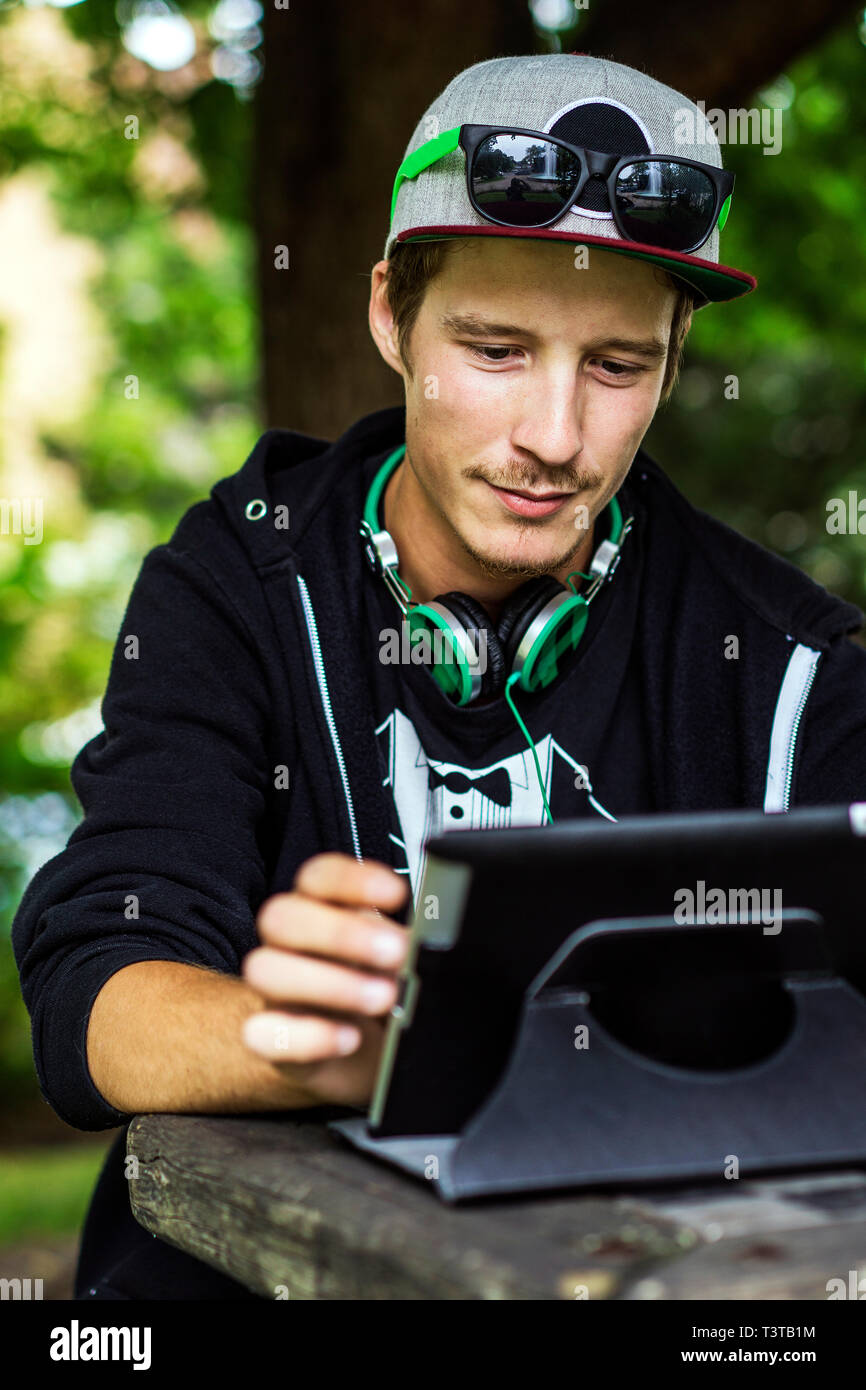 Caucasian man using digital tablet outdoors Stock Photo