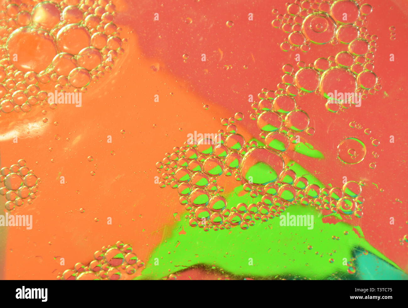 oil bubble floating on water surface in color background Stock Photo