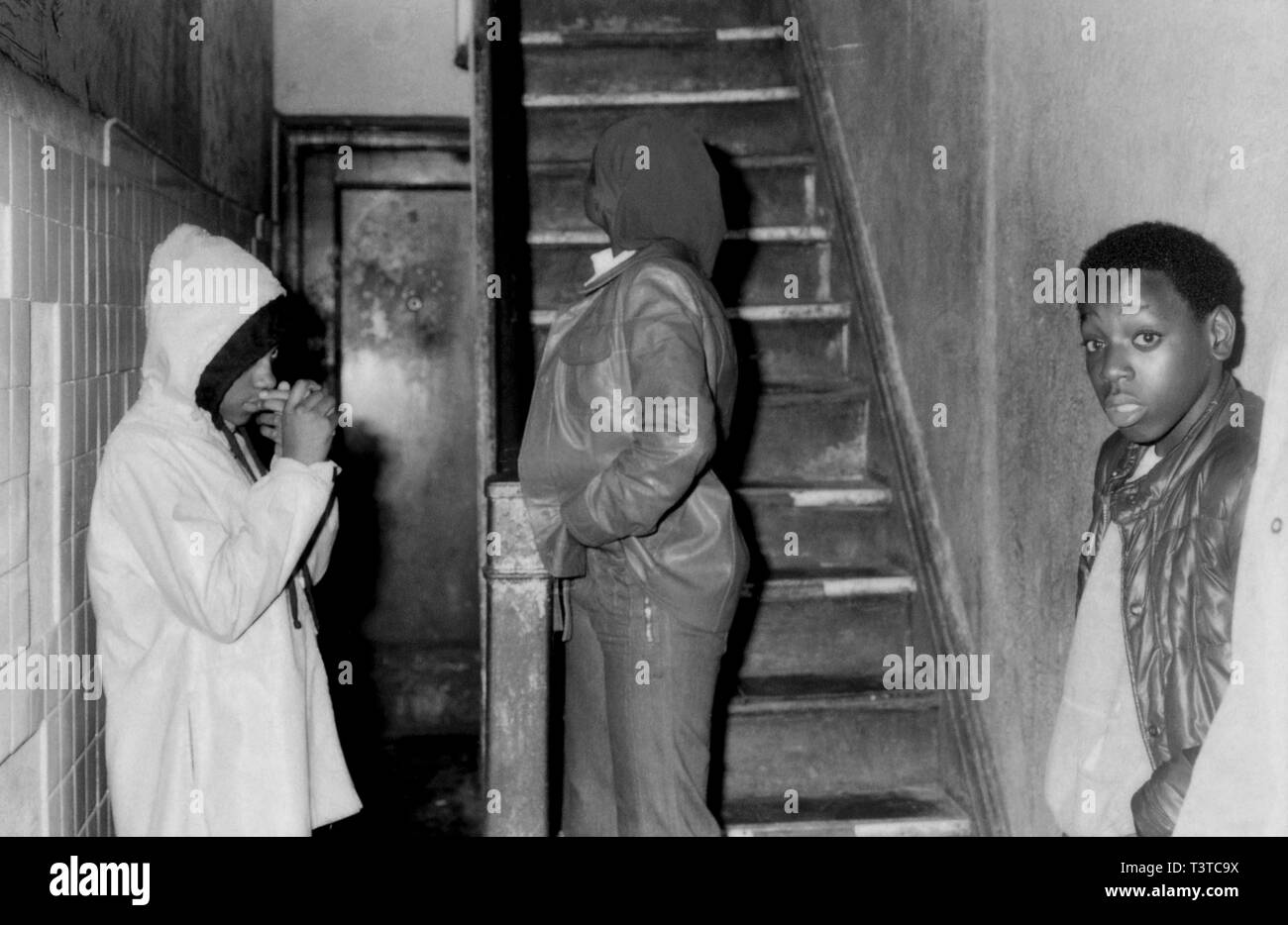 African American teenagers in stairway of apartment block in Harlem 70s