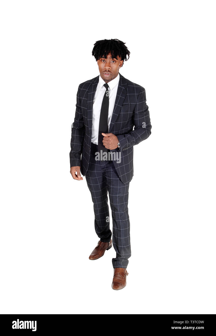 An young African American man in a dark gray suit and tie standing in ...