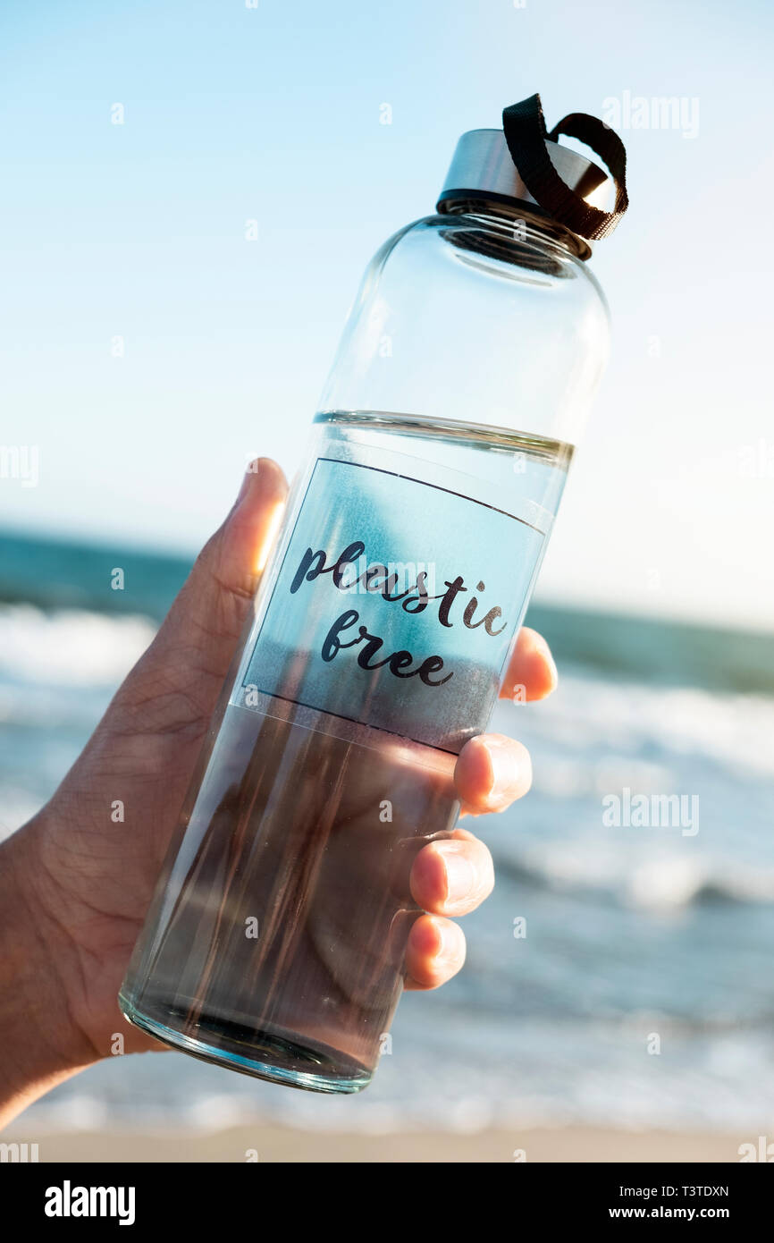 Reusable water bottle on the beach Stock Photo by ©nito103 278023088