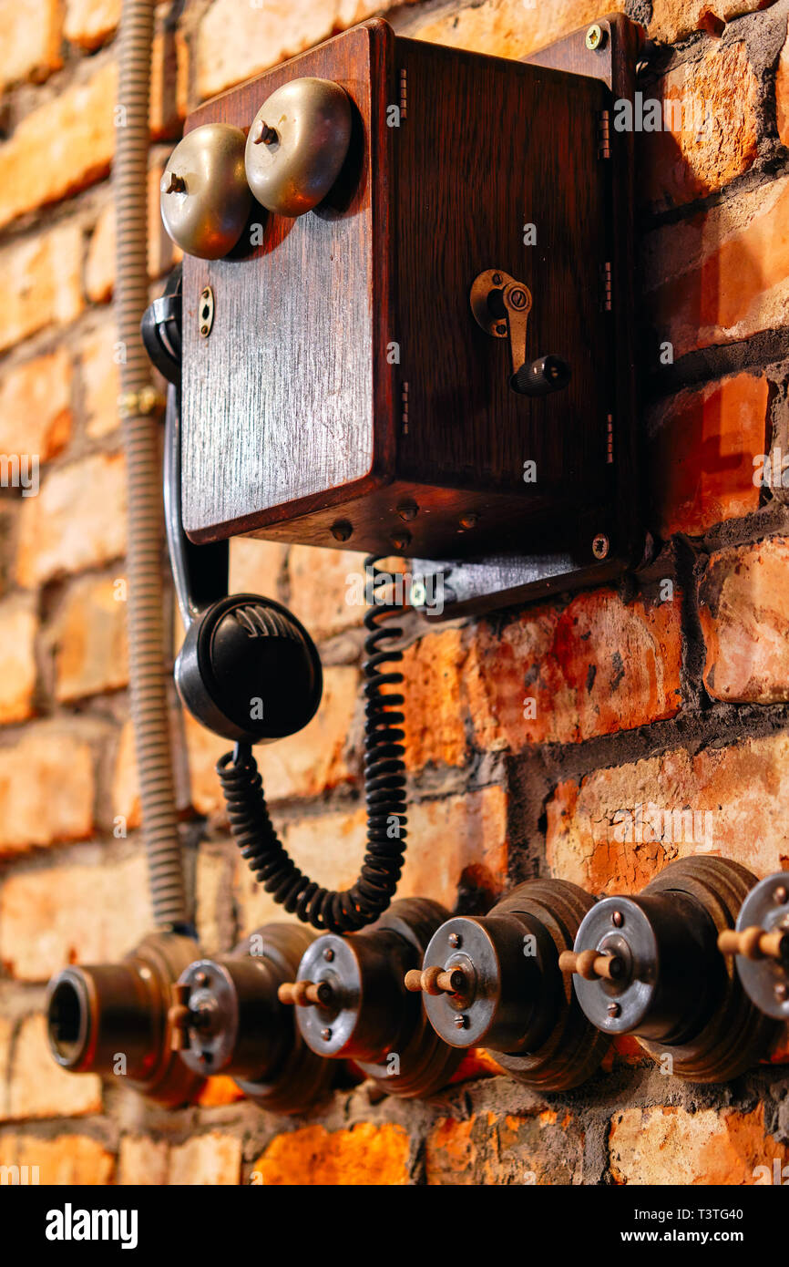 Vertical view telephone and turning on off lighting switches in a row ...