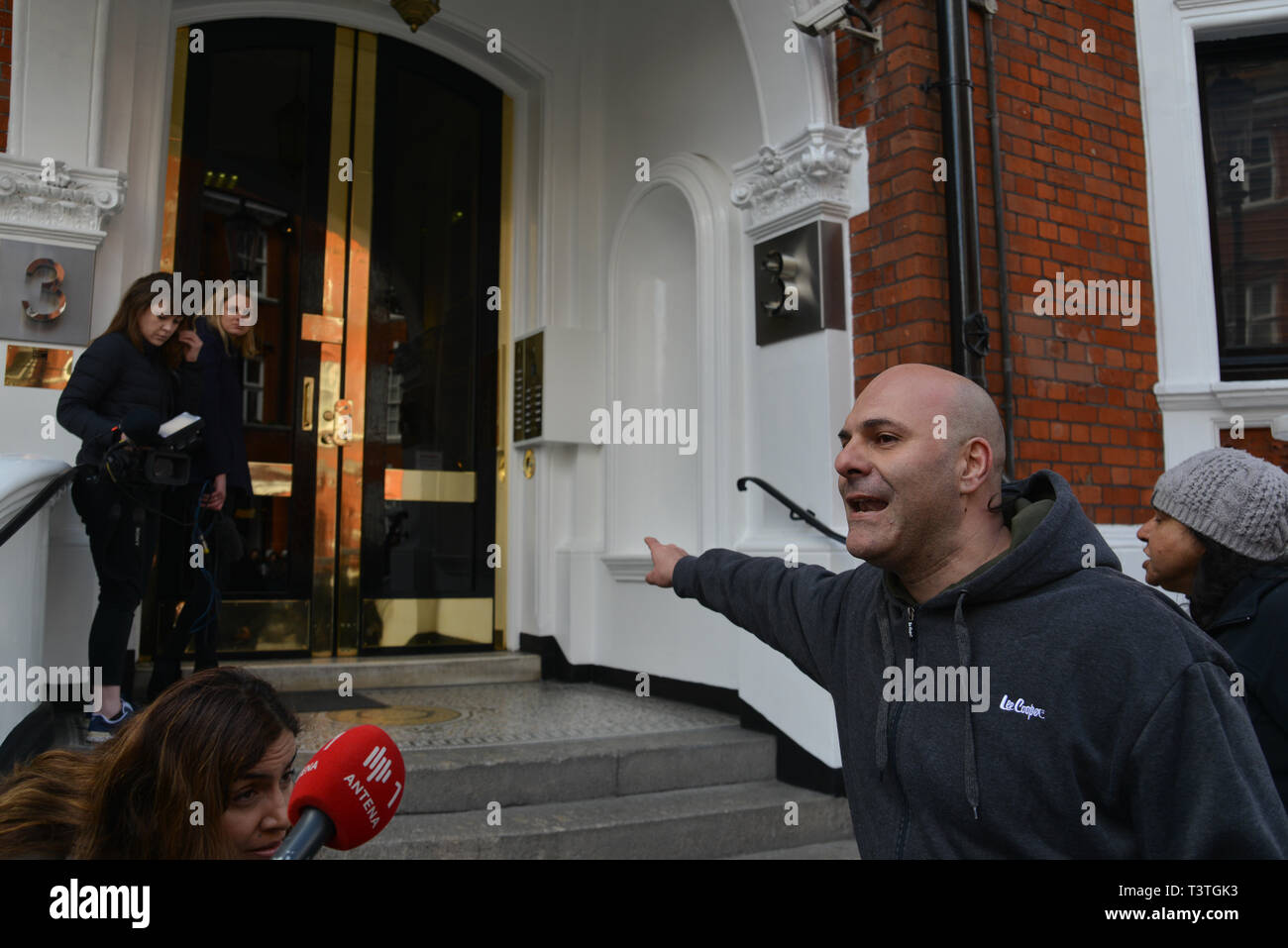 A 'Free Speech' activist and  journalist is interviewed at the entrance to the Embassy Of Ecuador in London, shortly after the WikiLeaks founder Julian Assange was removed from the embassy and arrested by the British Police. Stock Photo