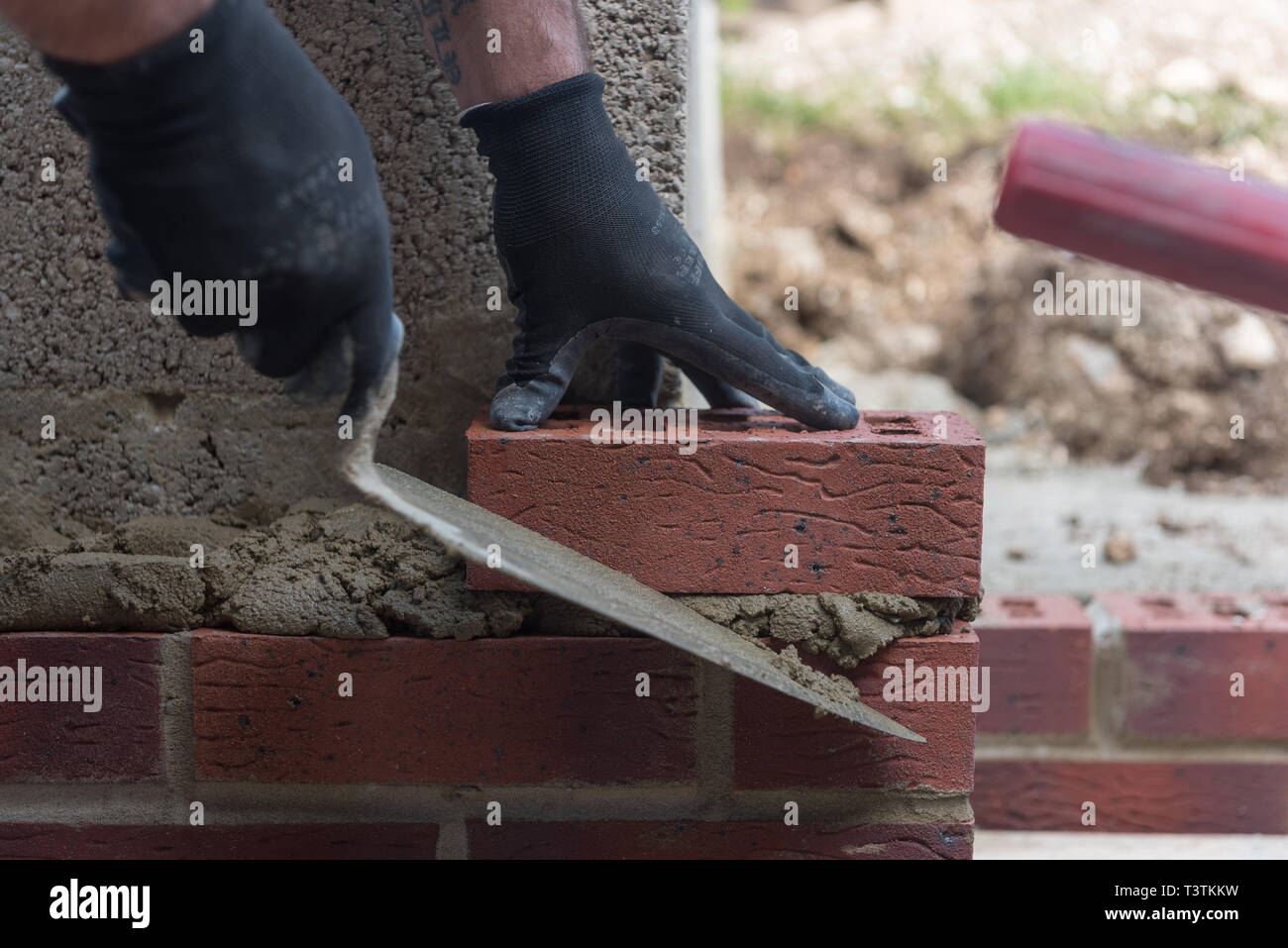 brick laying close up of hands and trowel Stock Photo