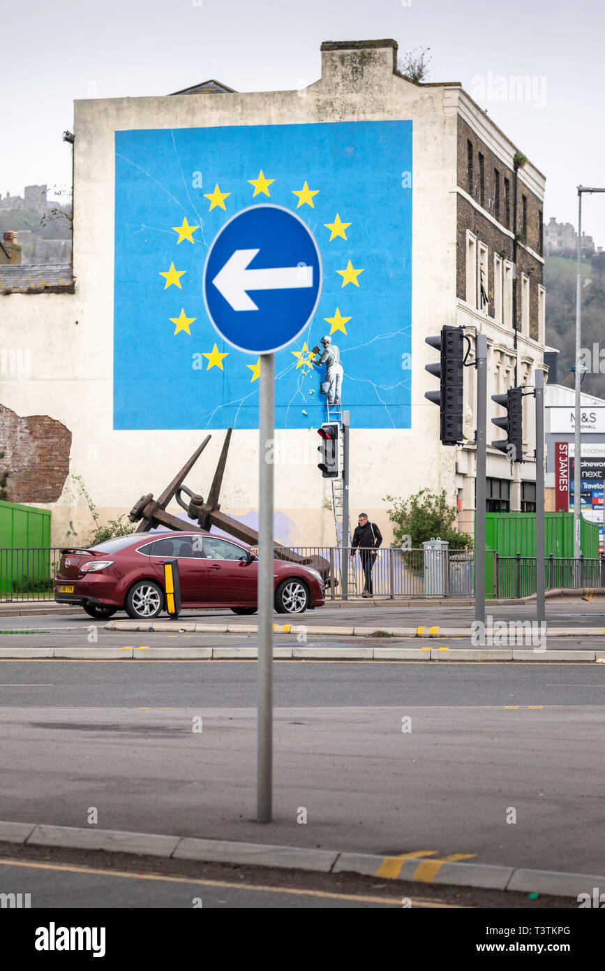 What next for Brexit?? A road sign indicates one-way from Banksy's famous Brexit mural on the side of a derelict building in Dover.  Picture date Wedn Stock Photo
