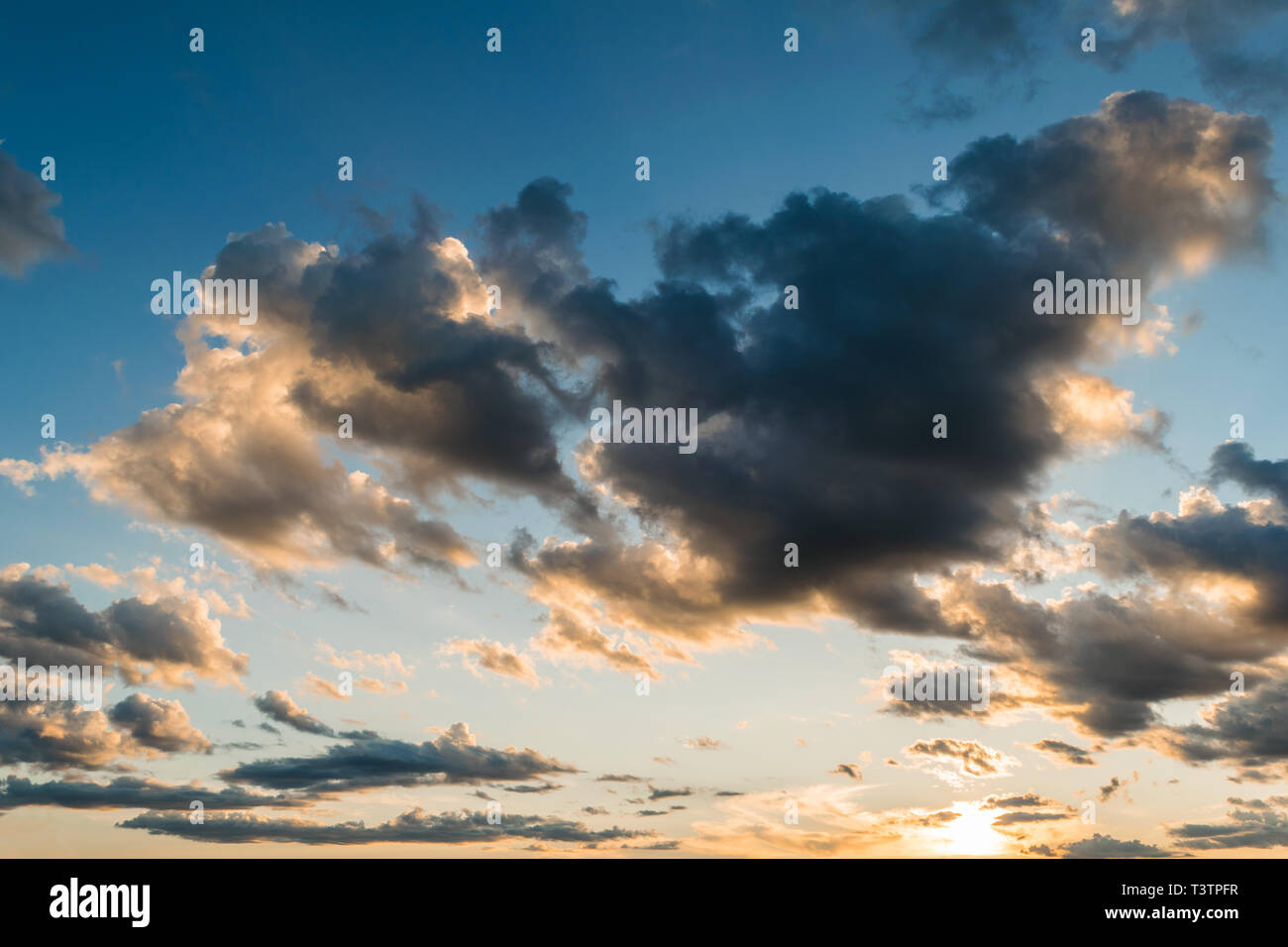 Blue sky and dramatic backlit cloud formation during sunset Stock Photo ...