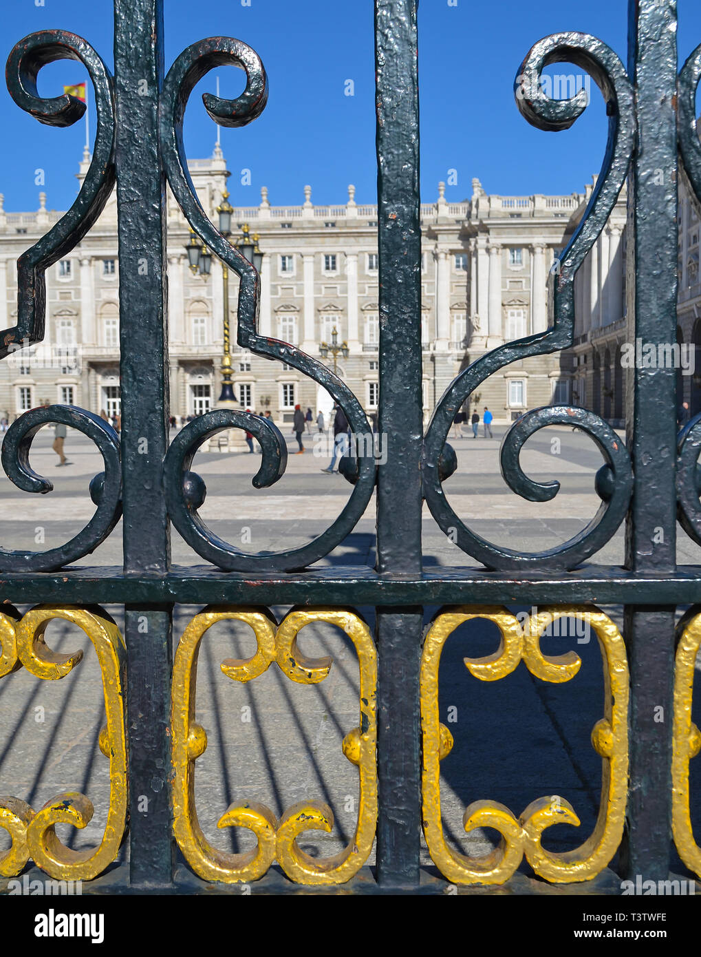 Royal Palace of Madrid viewed through the black and gold gate railings Stock Photo
