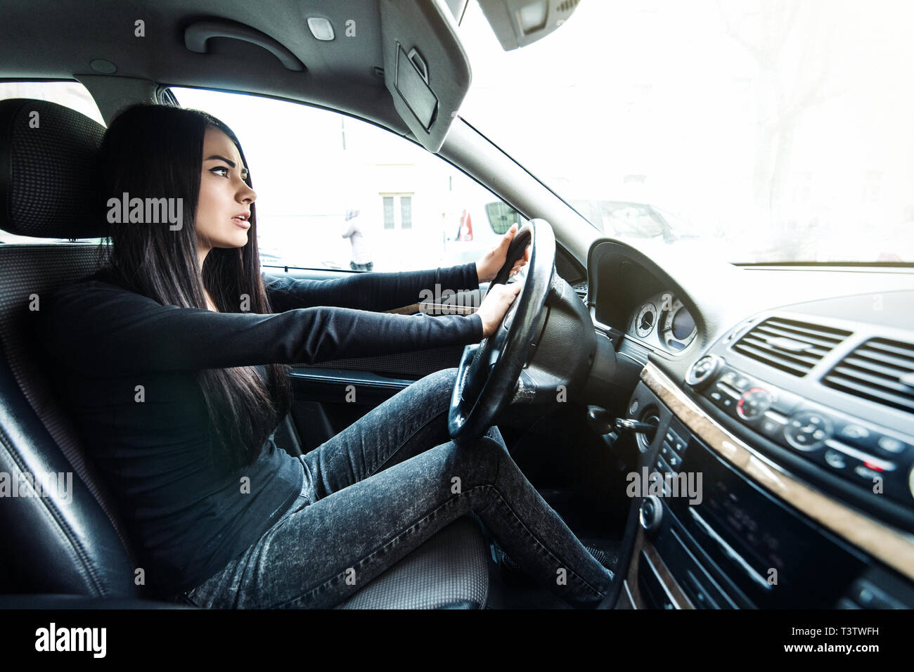 transportation and vehicle concept - woman driving a car with hand on horn button Stock Photo