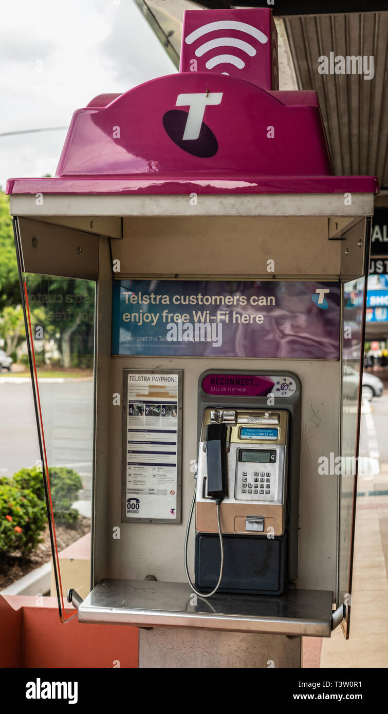 Cairns, Australia - February 17, 2019: Closeup of Telstra Public payphone with free wifi hotspot on Abbott Street. Stock Photo