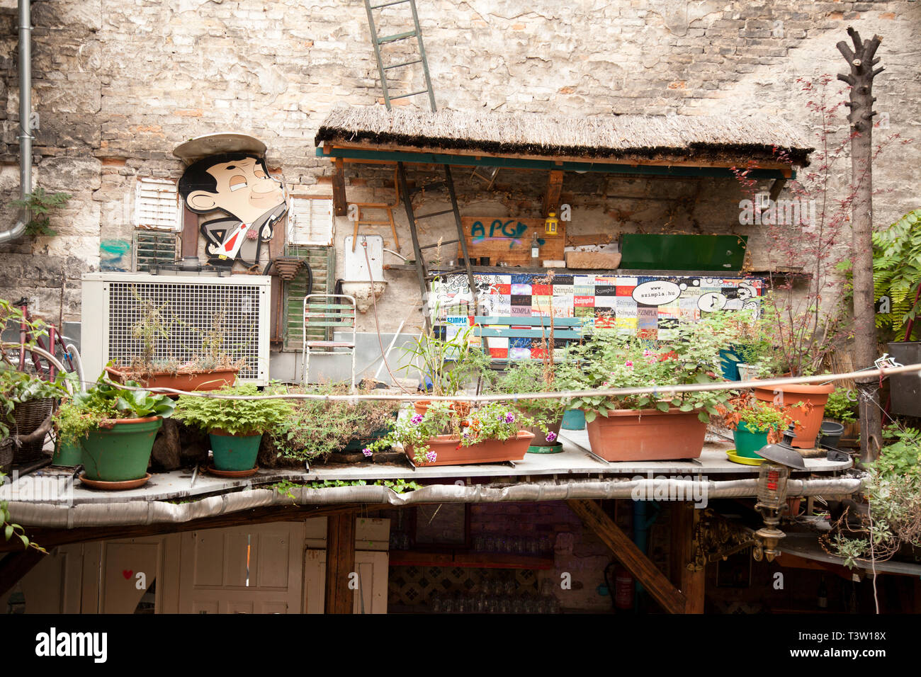 BUDAPEST, HUNGARY - SEPTEMBER 20, 2017: Szimpla Kert isa huge and eclectic pub with old mismatched items & a disused Trabant car, with music, food, ma Stock Photo