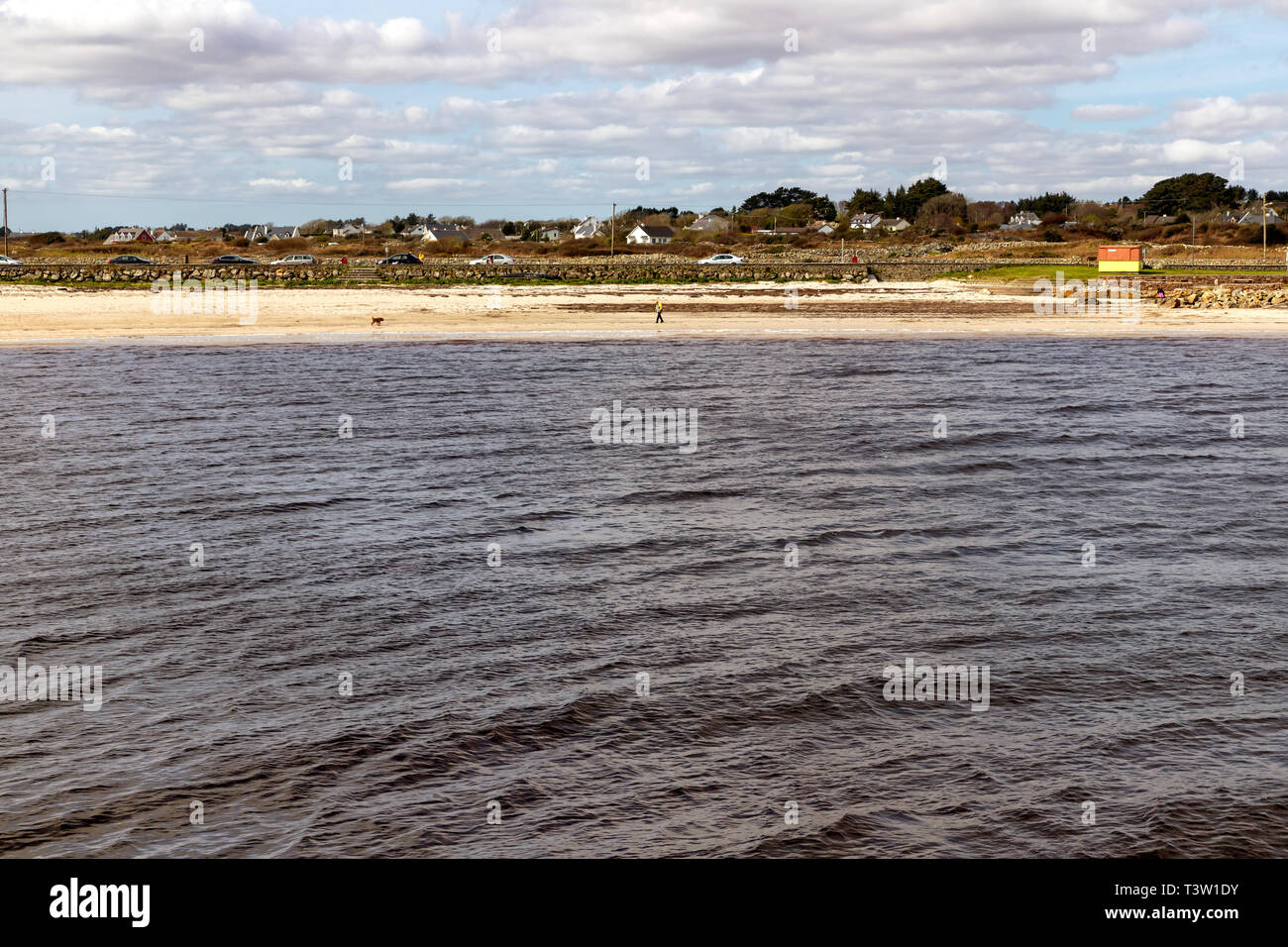 Beach with sand and buildings in Galway Bay, Spiddal, Galway, Ireland Stock Photo