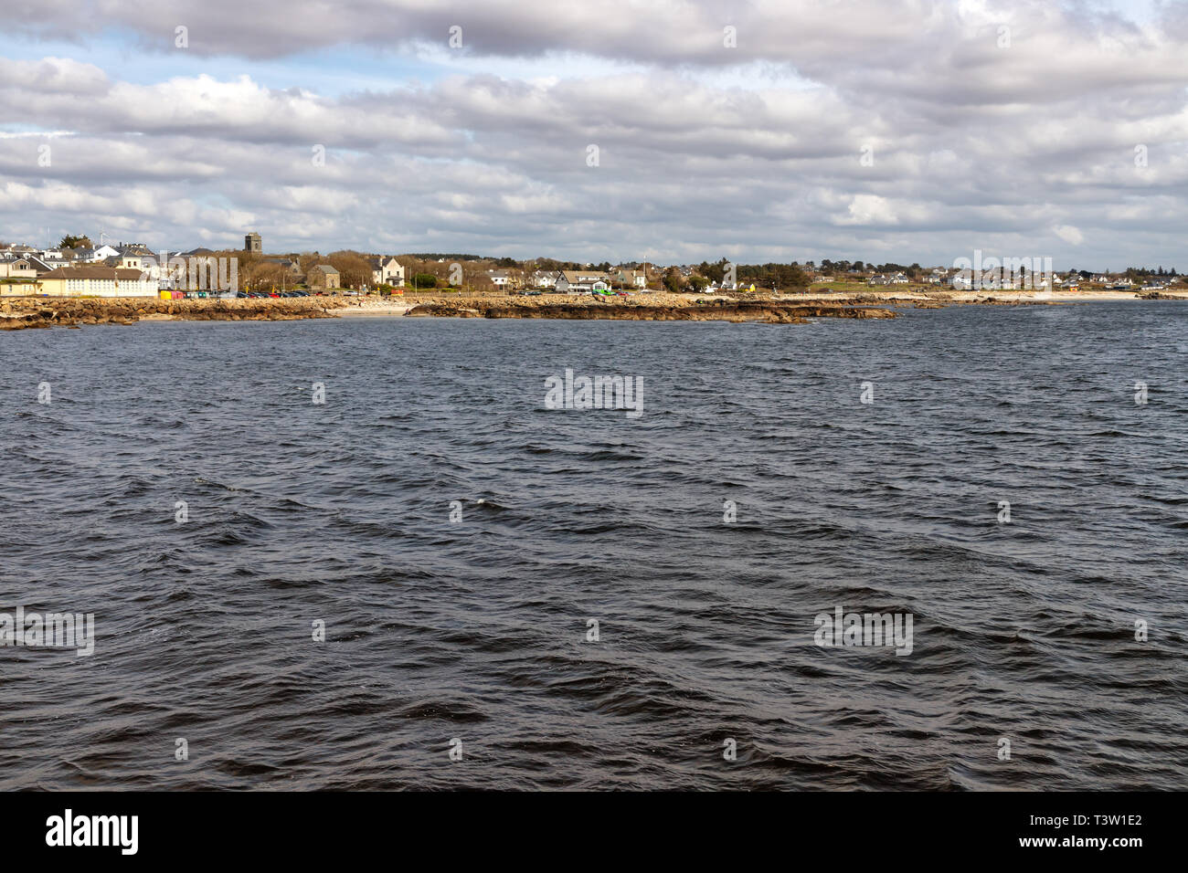 Beach with sand and buildings in Galway Bay, Spiddal, Galway, Ireland Stock Photo