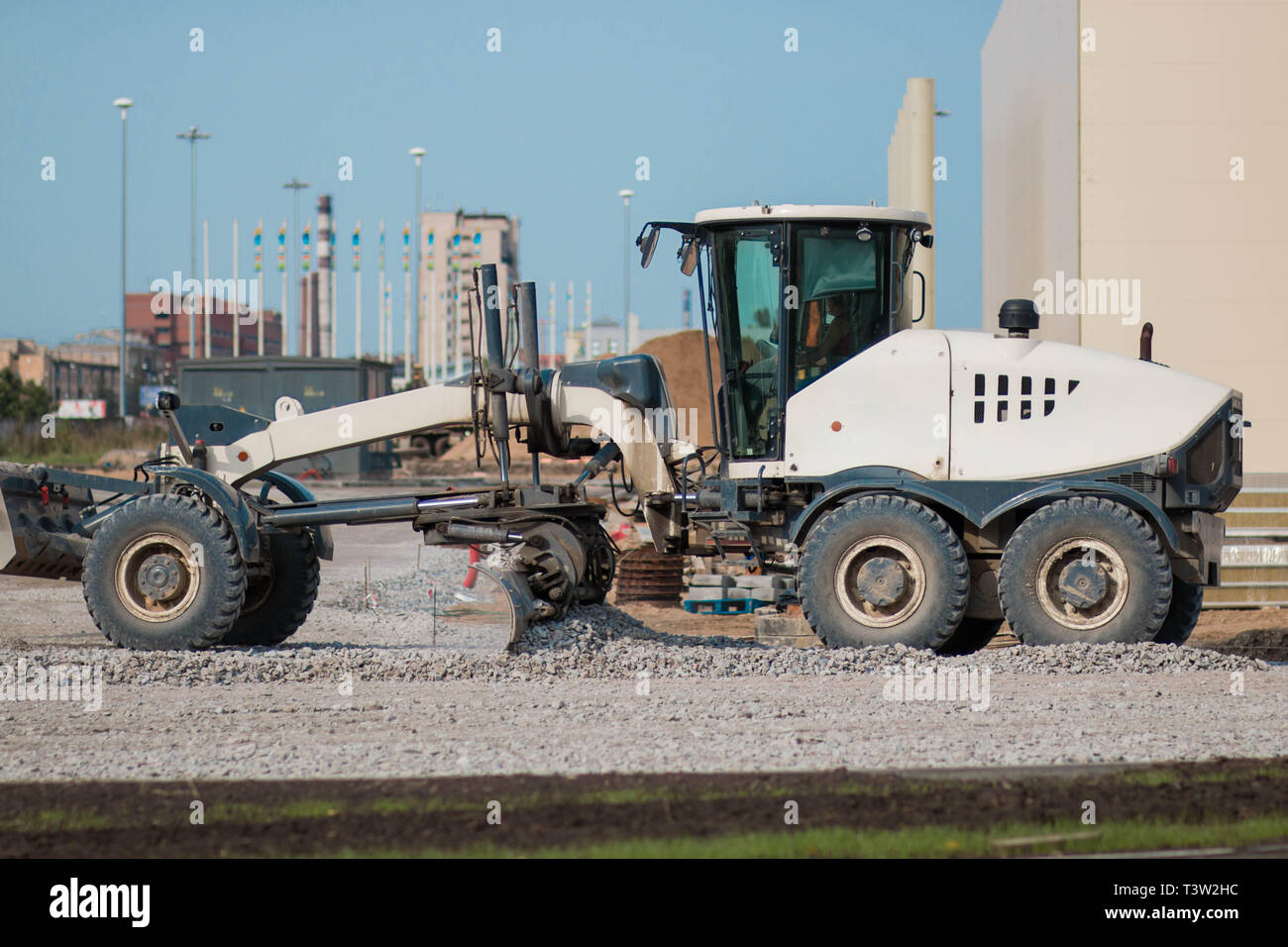 SAINT PETERSBURG, RUSSIA - AUGUST 31, 2017 A white tractor is building a road Stock Photo