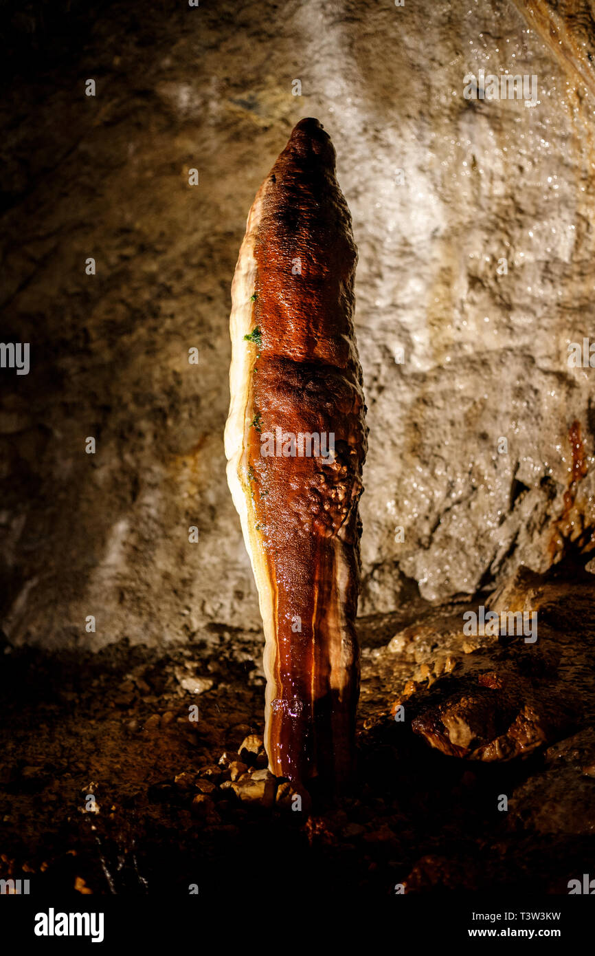 massive stalagmite in a cave Stock Photo