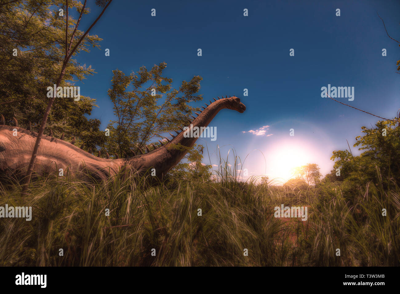 Dinosaur in Tall Grass at Sunrise - Photoshop Compositing Stock Photo