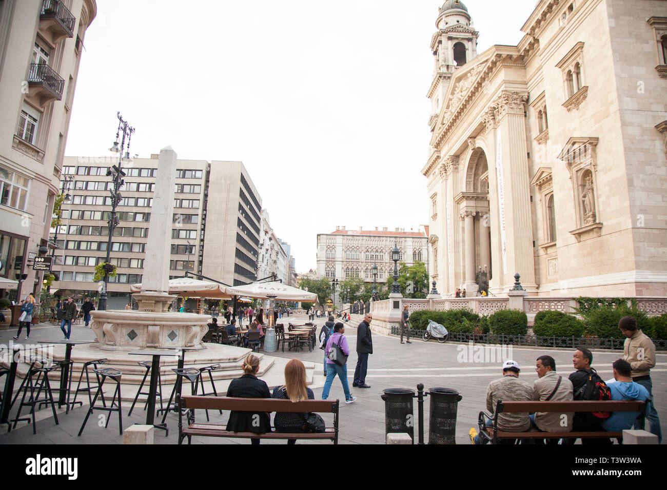 BUDAPEST, HUNGARY - SEPTEMBER 20, 2017: The square in front of St. Stephens Basilica in Budapest, is surrounded by restaurants and patios where many p Stock Photo