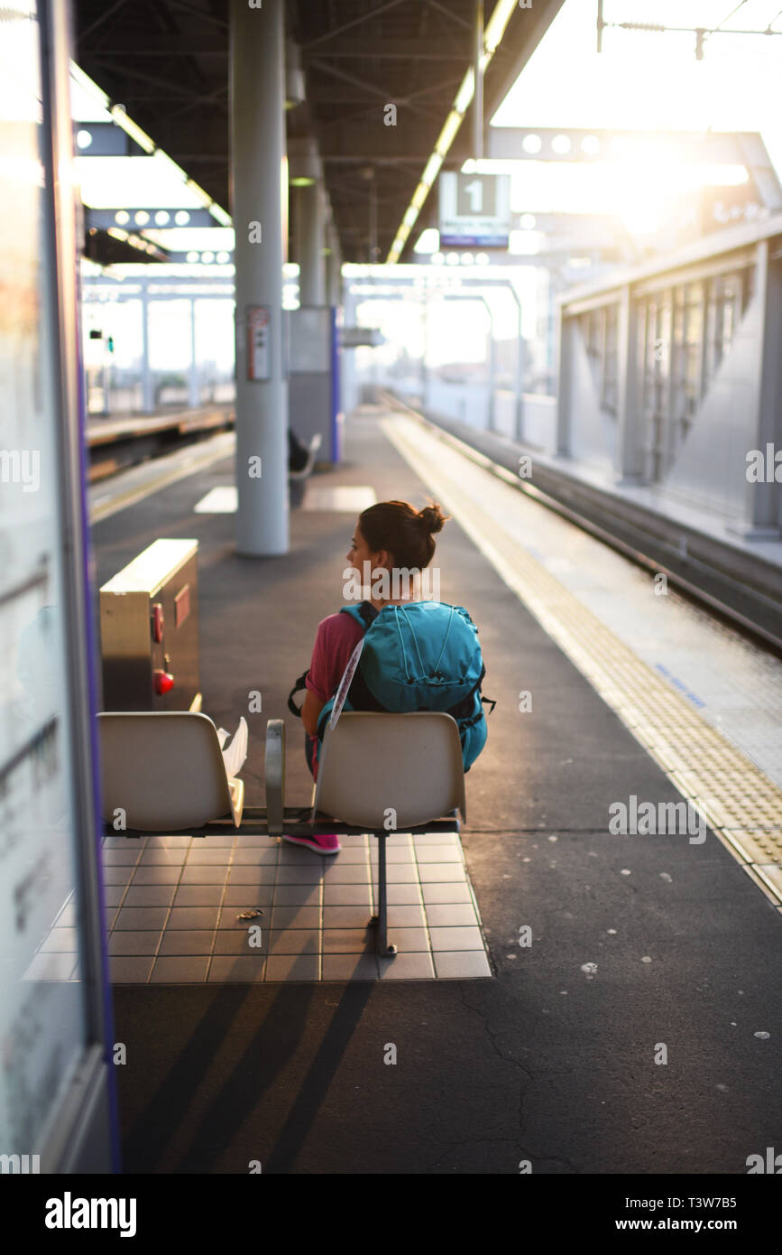 Young woman waits for transfer train to Kansai Airport, Japan Stock ...