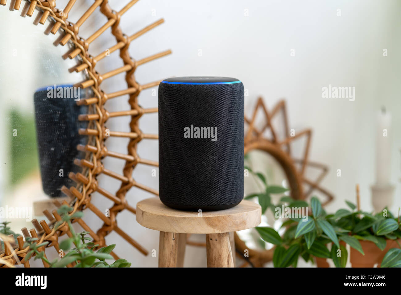 Personal assistant connected loudspeaker on a small wooden table in a