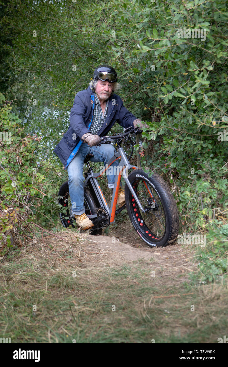 A man rides an electric bike UK Stock Photo