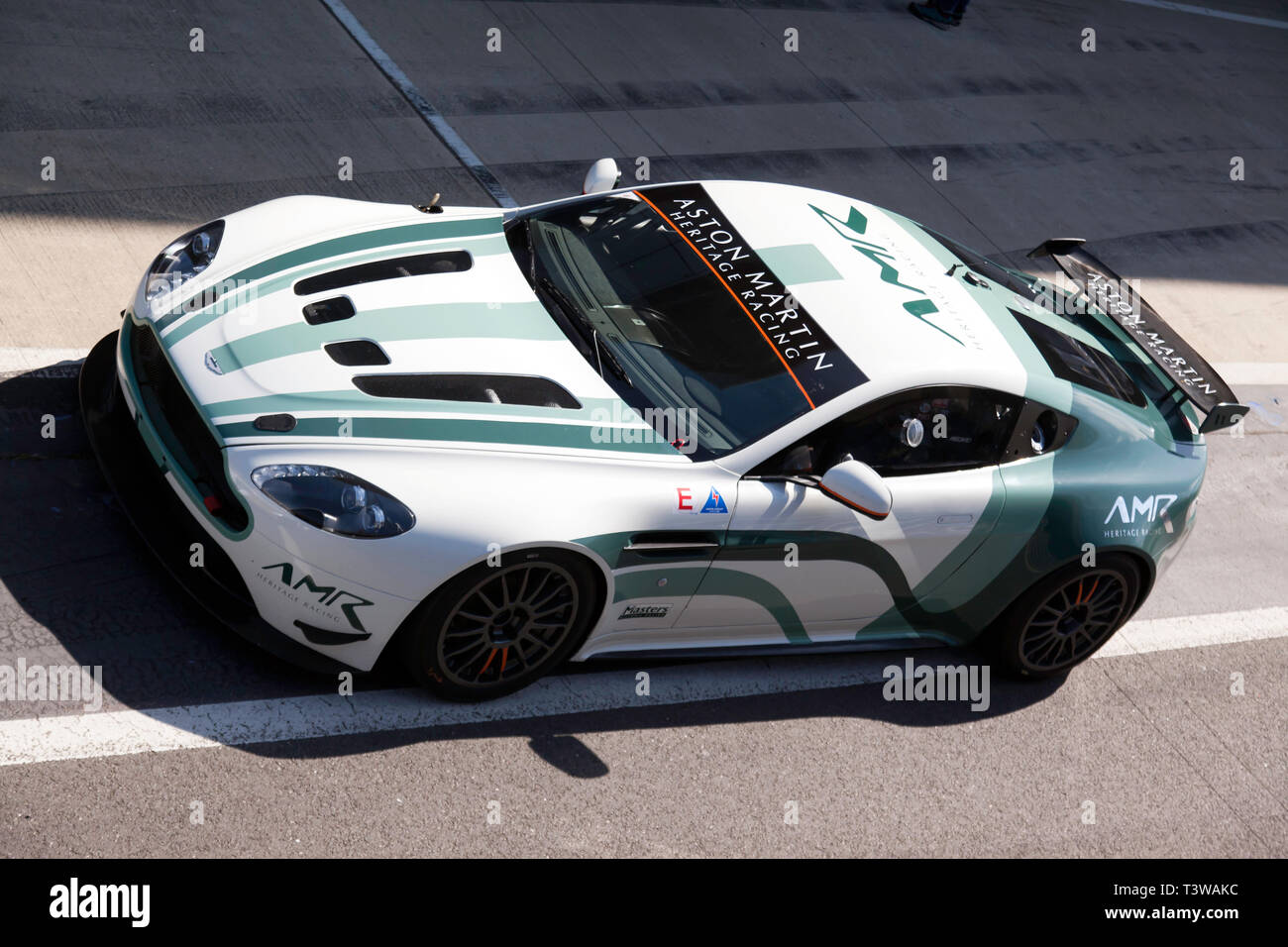 Aerial view of an 2015, Aston Martin Vantage GT4,  exiting the pit lane at the 2019 Silverstone Classic Media/Test Day Stock Photo