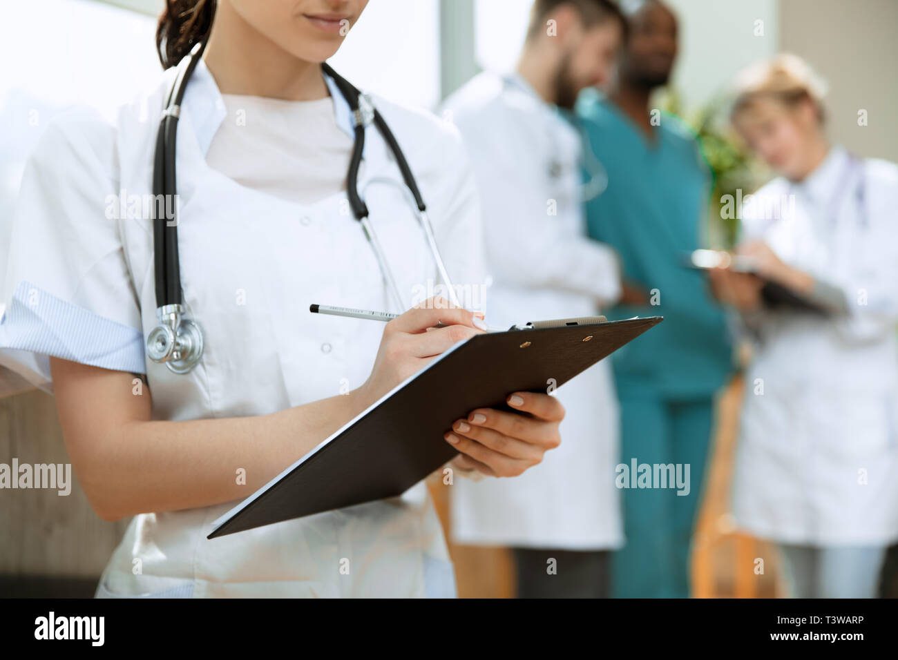 Healthcare people group. Professional female doctor posing at hospital