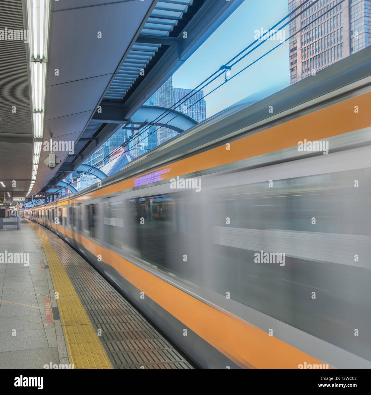 Blurred view of train leaving platform, Tokyo, Japan Stock Photo