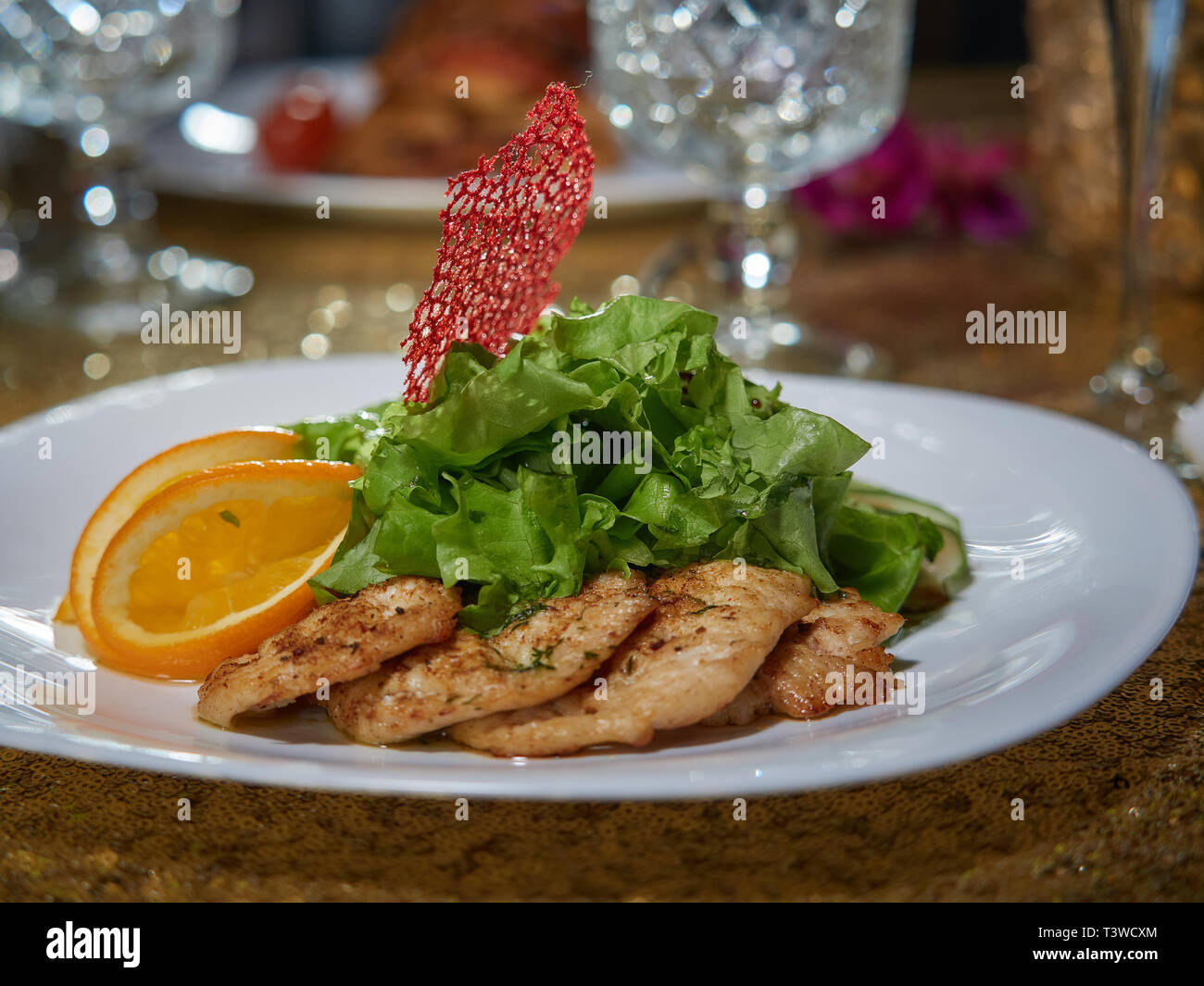 Fresh pieces of pork meat fried over an open fire. Served with lemon slices and green lettuce. Stock Photo