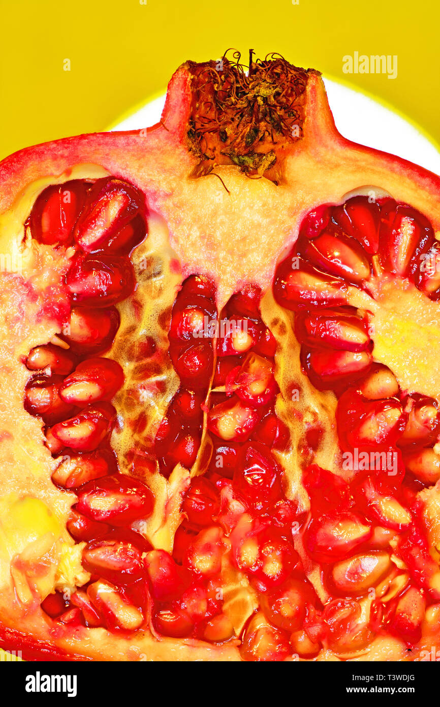 Voluptuous sliced pomegranate and red seed fruit Stock Photo