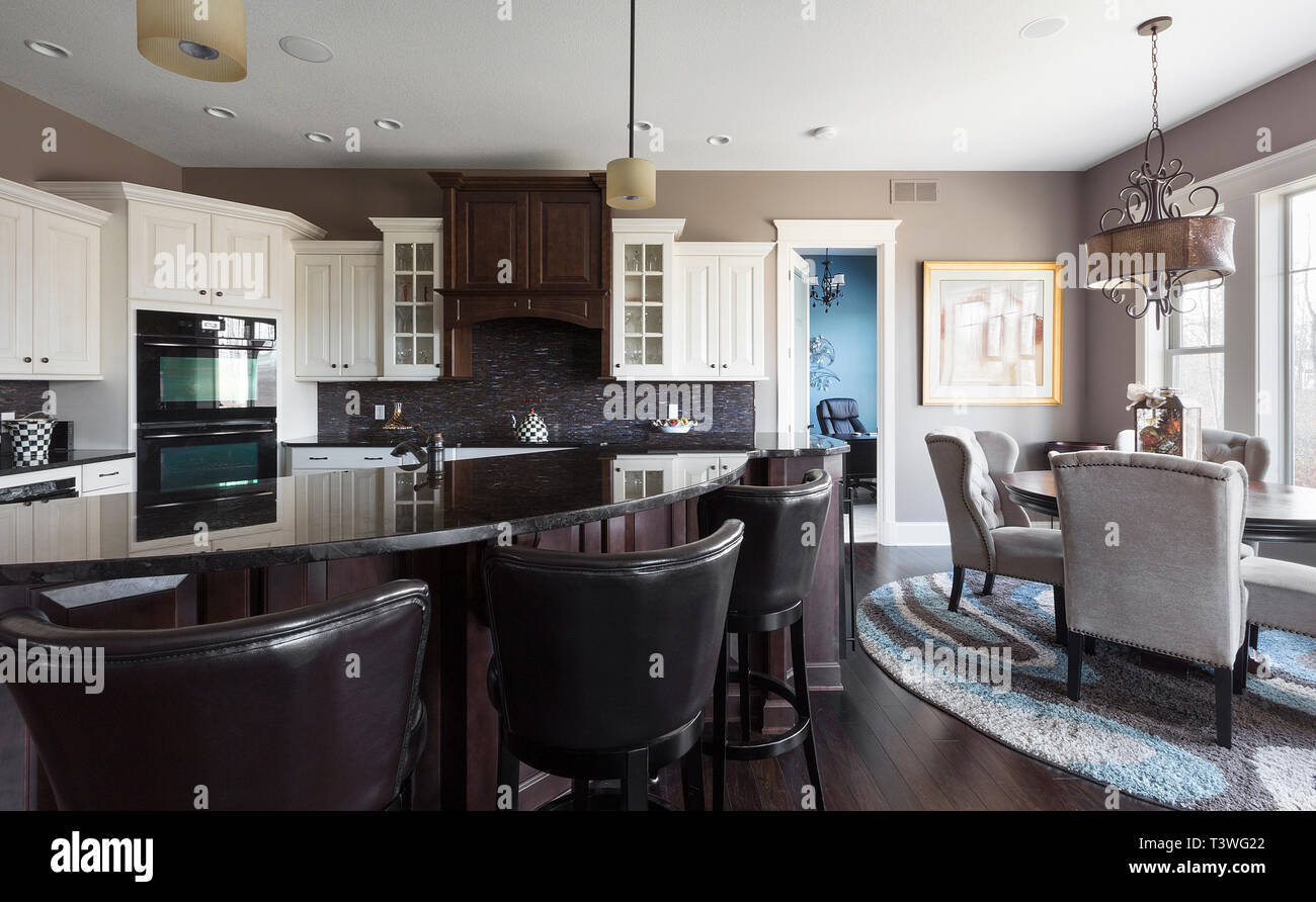 Island and dining table in open kitchen space Stock Photo - Alamy