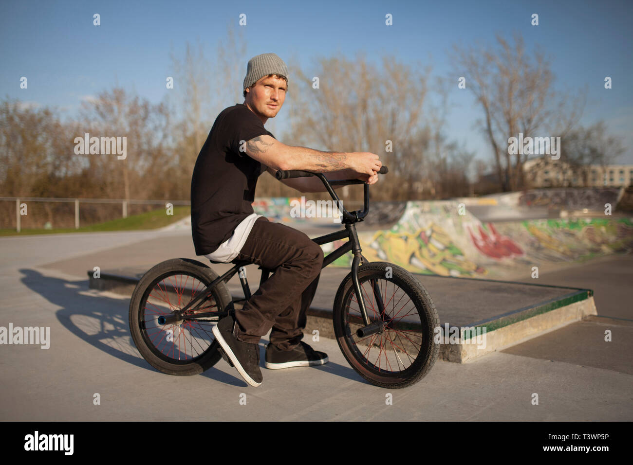 Caucasian man riding BMX bicycle at skate park Stock Photo - Alamy