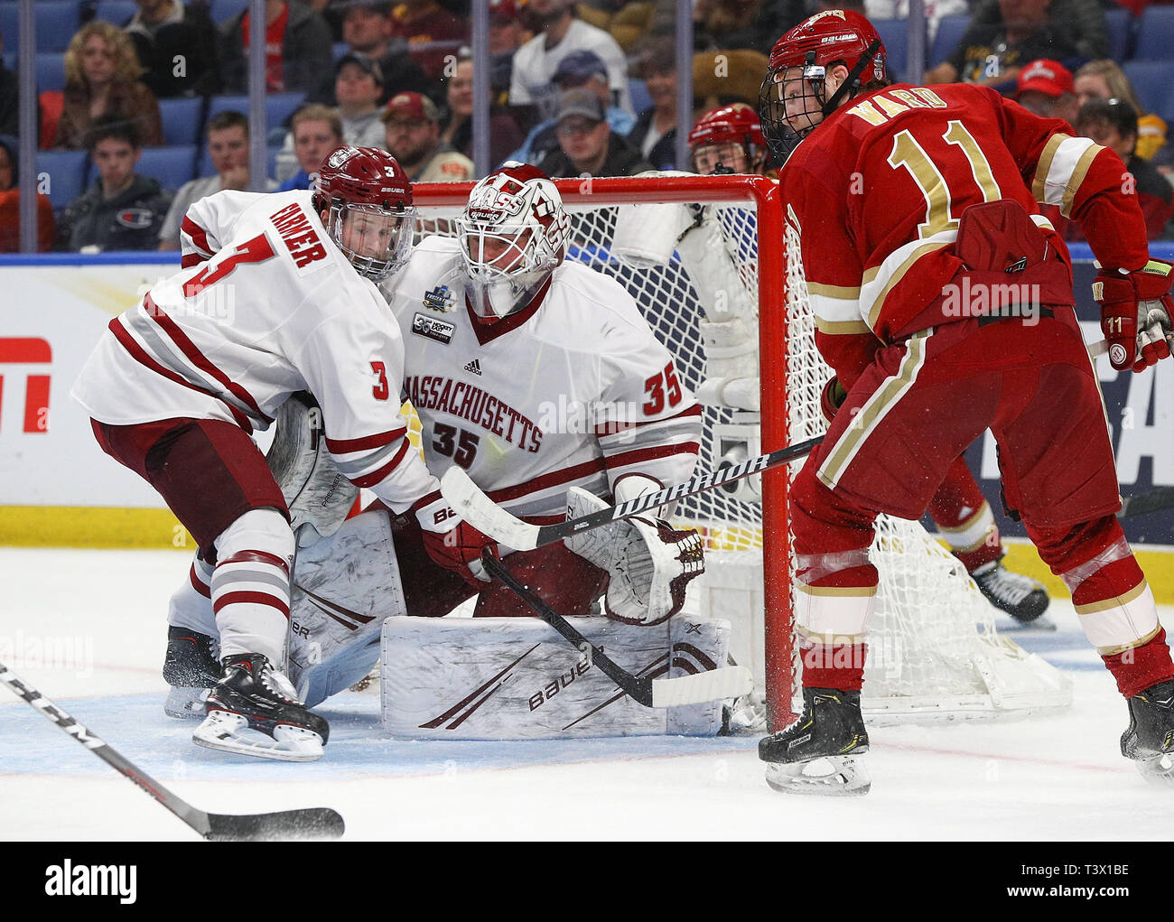 Buffalo, NY, USA. 11th Apr 2019. Massachusetts Minutemen defenseman Ty Farmer (3) assists goaltender Filip Lindberg (35) in front of the net with Denver Pioneers forward Tyler Ward (11) looking for a rebound during the second period of play in the 2019 NCAA Frozen Four Men's Hockey Semi-Final game between the Denver Pioneers and Massachusetts Minutemen at the KeyBank Center in Buffalo, N.Y. (Nicholas T. LoVerde/Cal Sport Media) Credit: Cal Sport Media/Alamy Live News Stock Photo