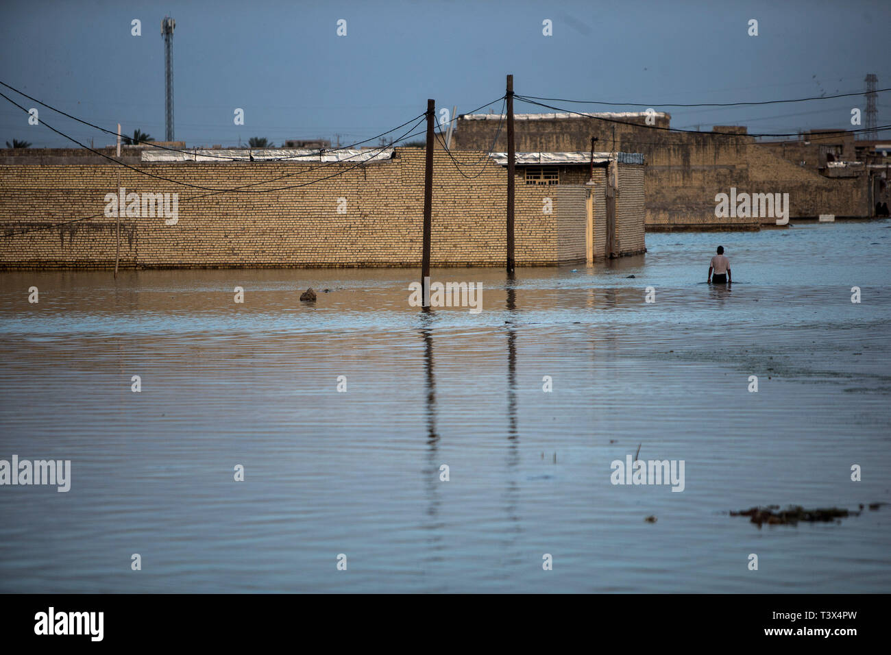 (190412) -- AHVAZ, April 12, 2019 (Xinhua) -- A man wades through flood waters just outside Ahvaz city, capital of Khuzestan province, Iran, April 11, 2019. (Xinhua/Ahmad Halabisaz) Stock Photo
