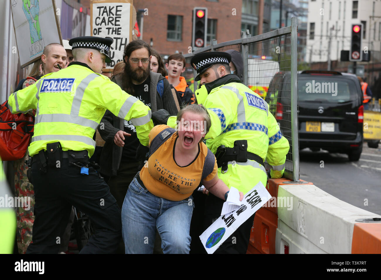 Manchester, UK. 12th Apr 2019. Police Officers use a passageway to block protesters from continuing with climate change action. A young girl panicked and broke away from officers, Manchester, UK, 12th April 2019 Credit: Barbara Cook/Alamy Live News Stock Photo