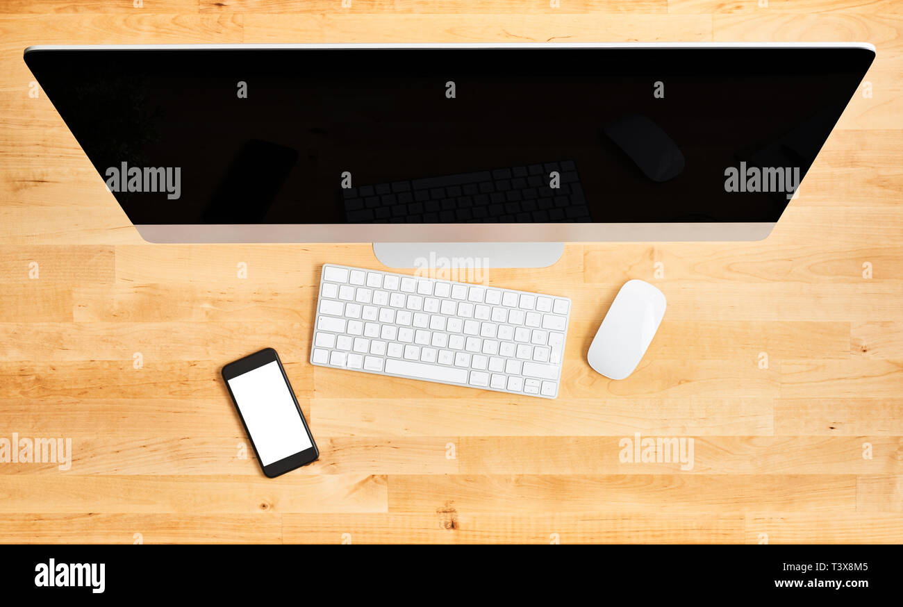 Desktop computer top view. Top view of wooden office desk with large ...
