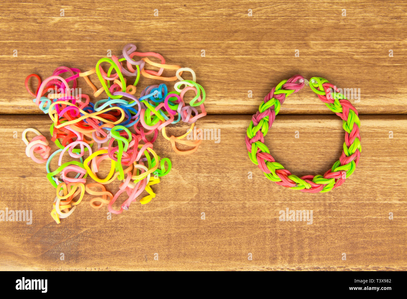 Chaos and order. Rubber bands for weaving loose and bracelet of rubber bands Stock Photo