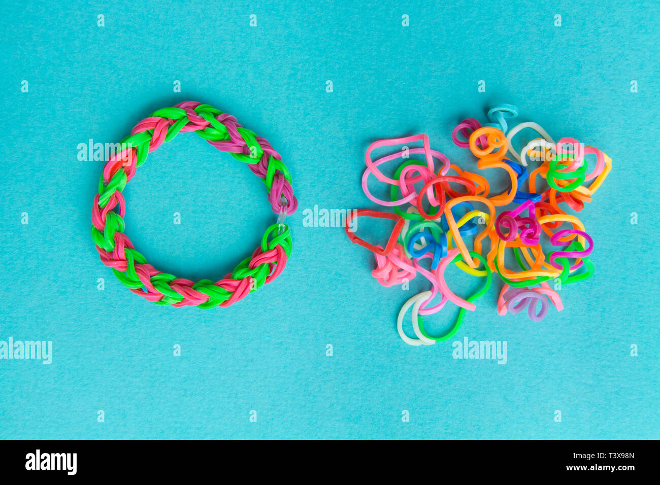 Chaos and order. Rubber bands for weaving loose and bracelet of rubber bands Stock Photo