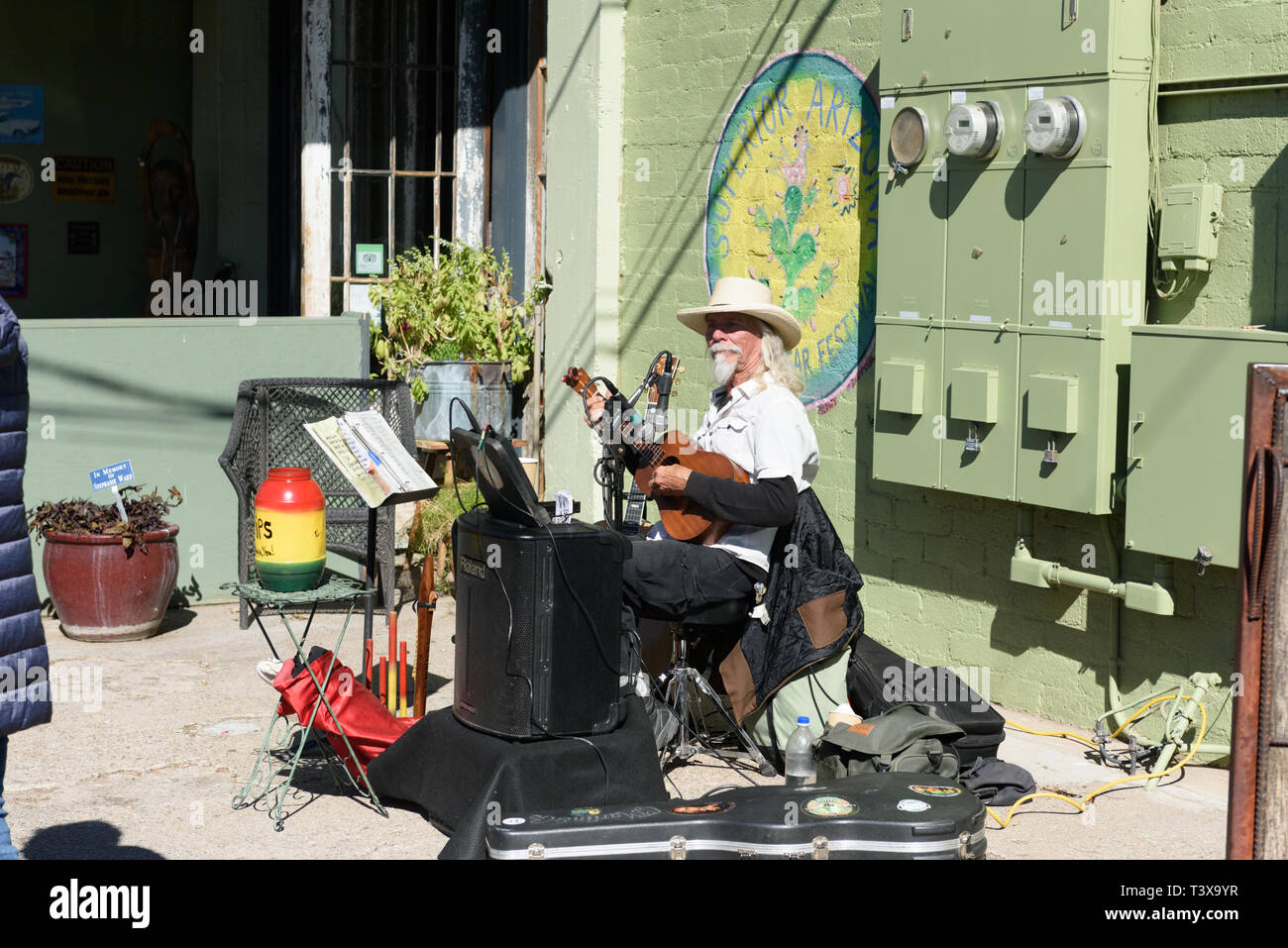 Superior, Arizona-February 8, 2019: Old cowboy with white beard plays a guitar while singing at a podium at a restaurant. Stock Photo