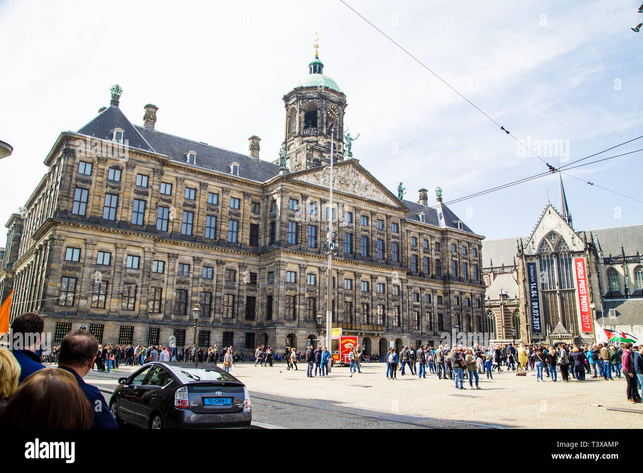 The Old Palace, Dam Square, Amsterdam, Netherlands. people go about their day in the main square. Stock Photo