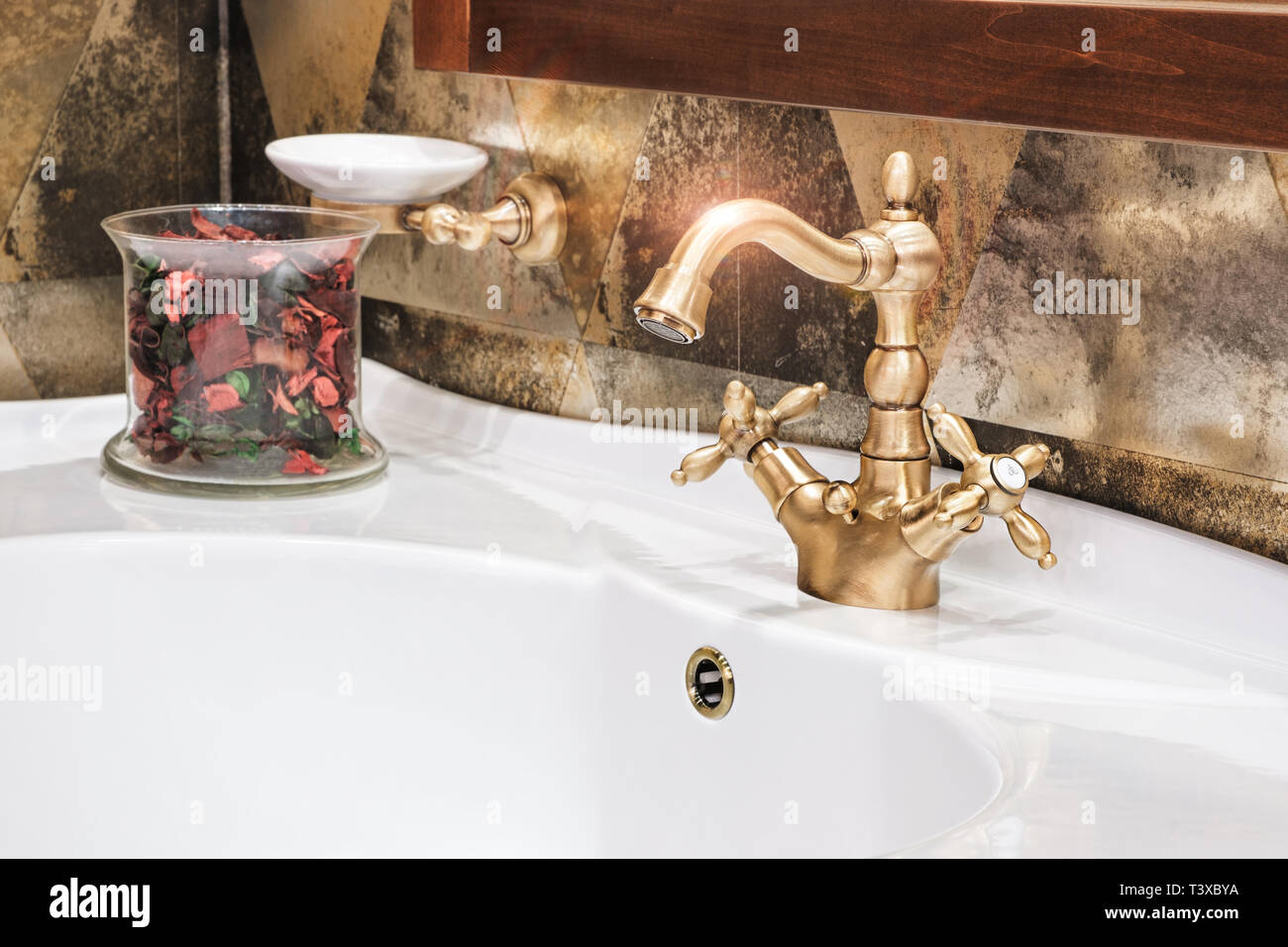 Retro golden faucet in the bathroom Stock Photo