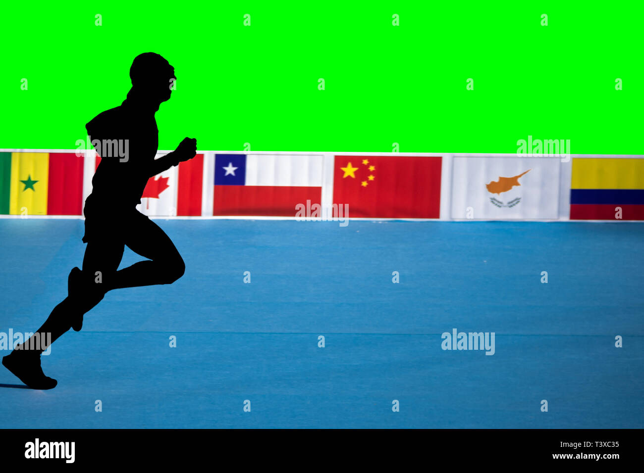 Fast marathon runner silhouette with green background and flags Stock Photo