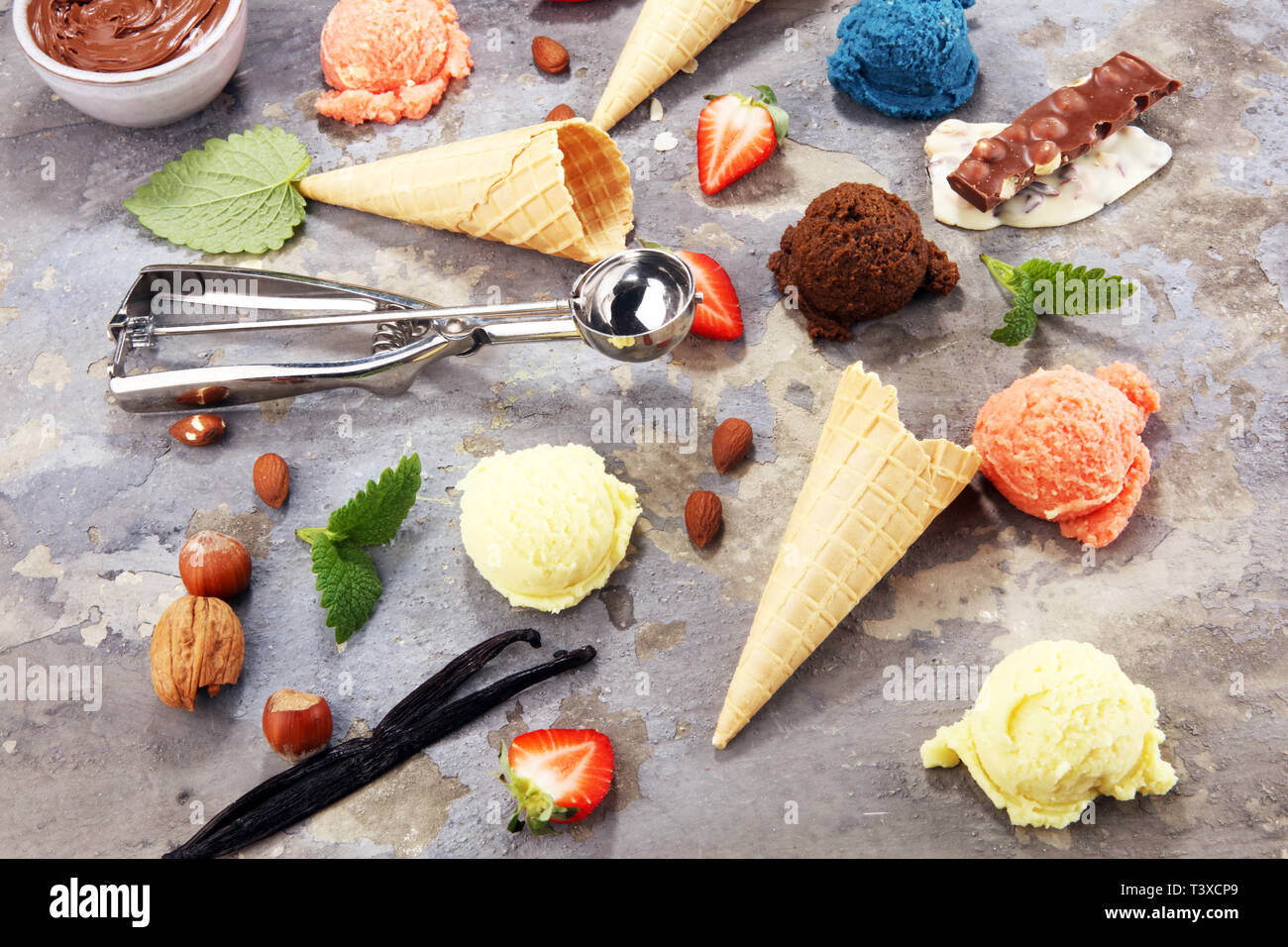 Set of ice cream scoops of different colors and flavours with berries