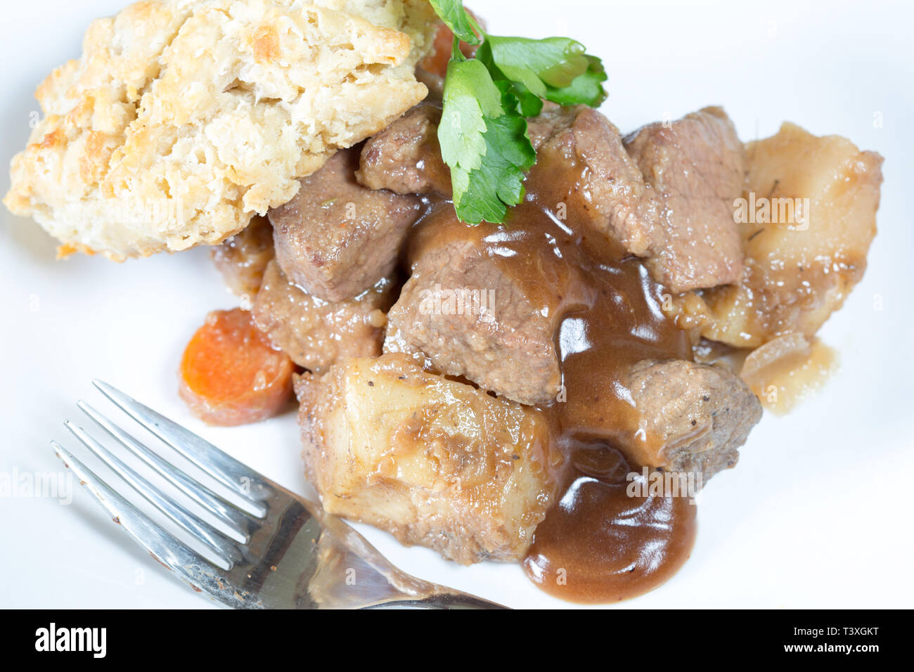 A classic plate of Beef stew served with a suet dumpling Stock Photo