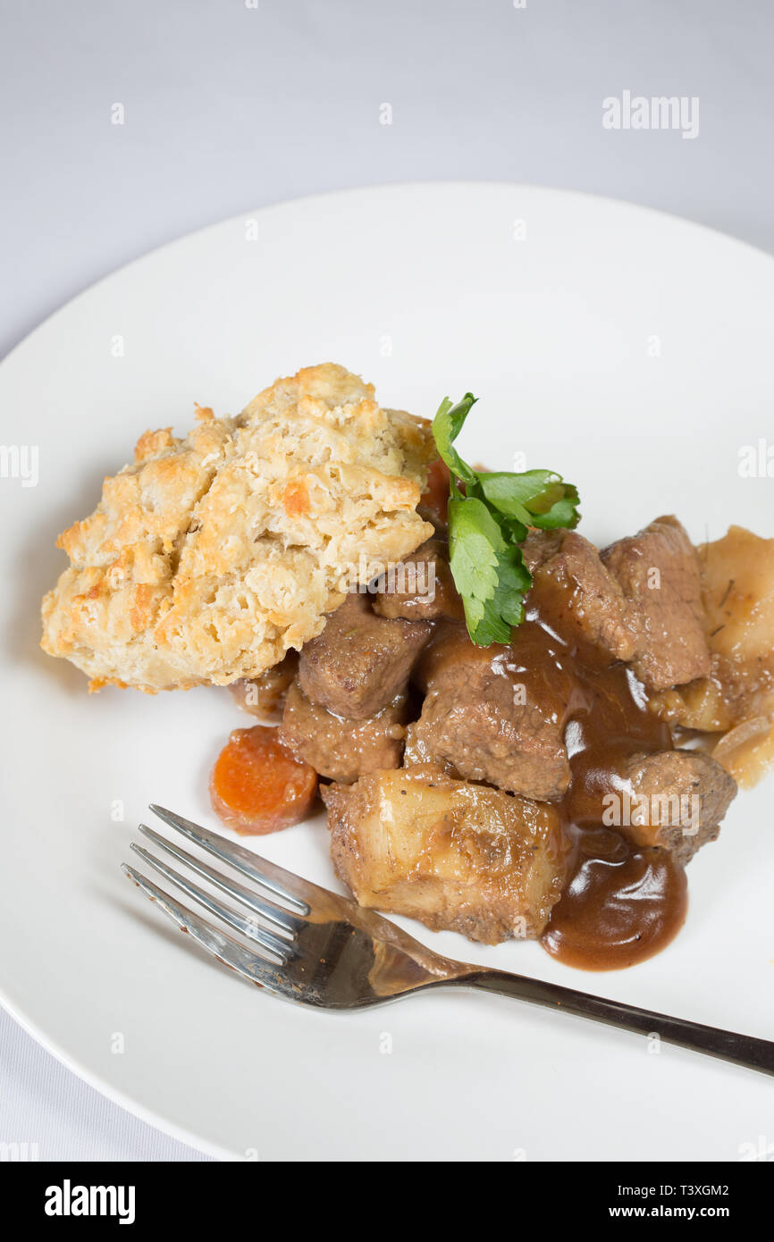 A classic plate of Beef stew served with a suet dumpling Stock Photo