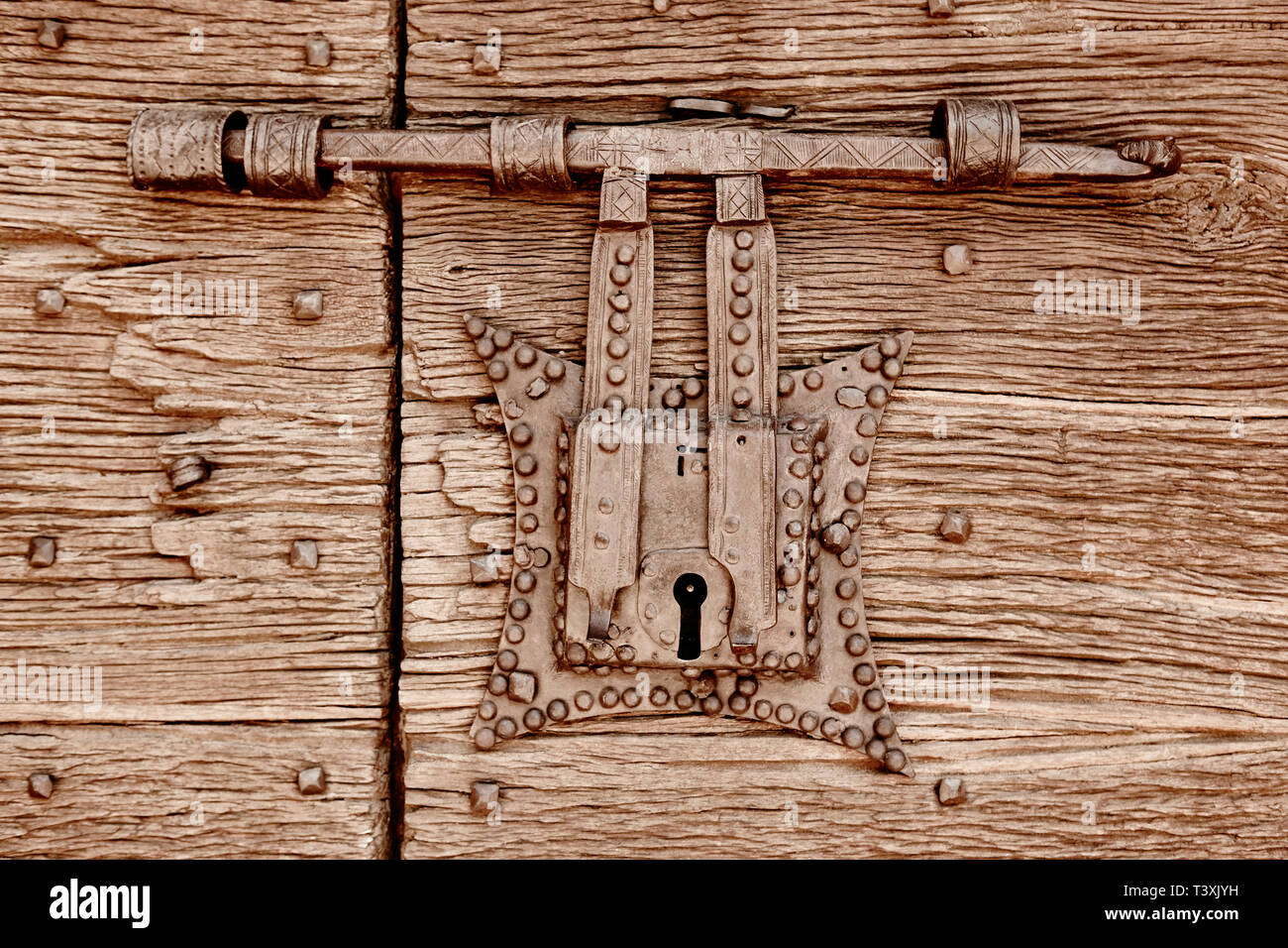 Antique metallic door lock on a wooden door. Vertical Stock Photo - Alamy