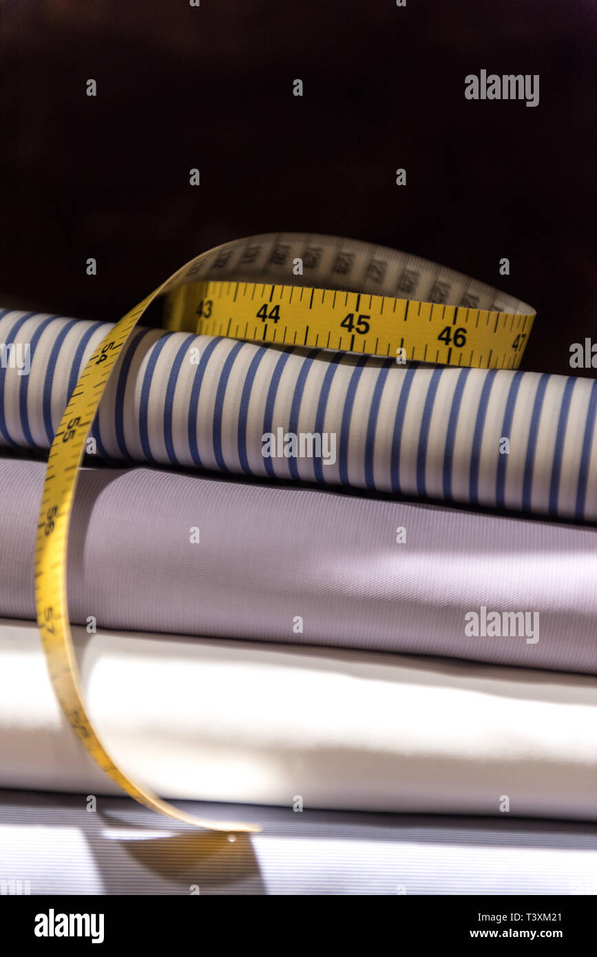 Tailor's Tape Measure and Fabric Swatches. Folded Mens Shirt Cloth Stock Photo