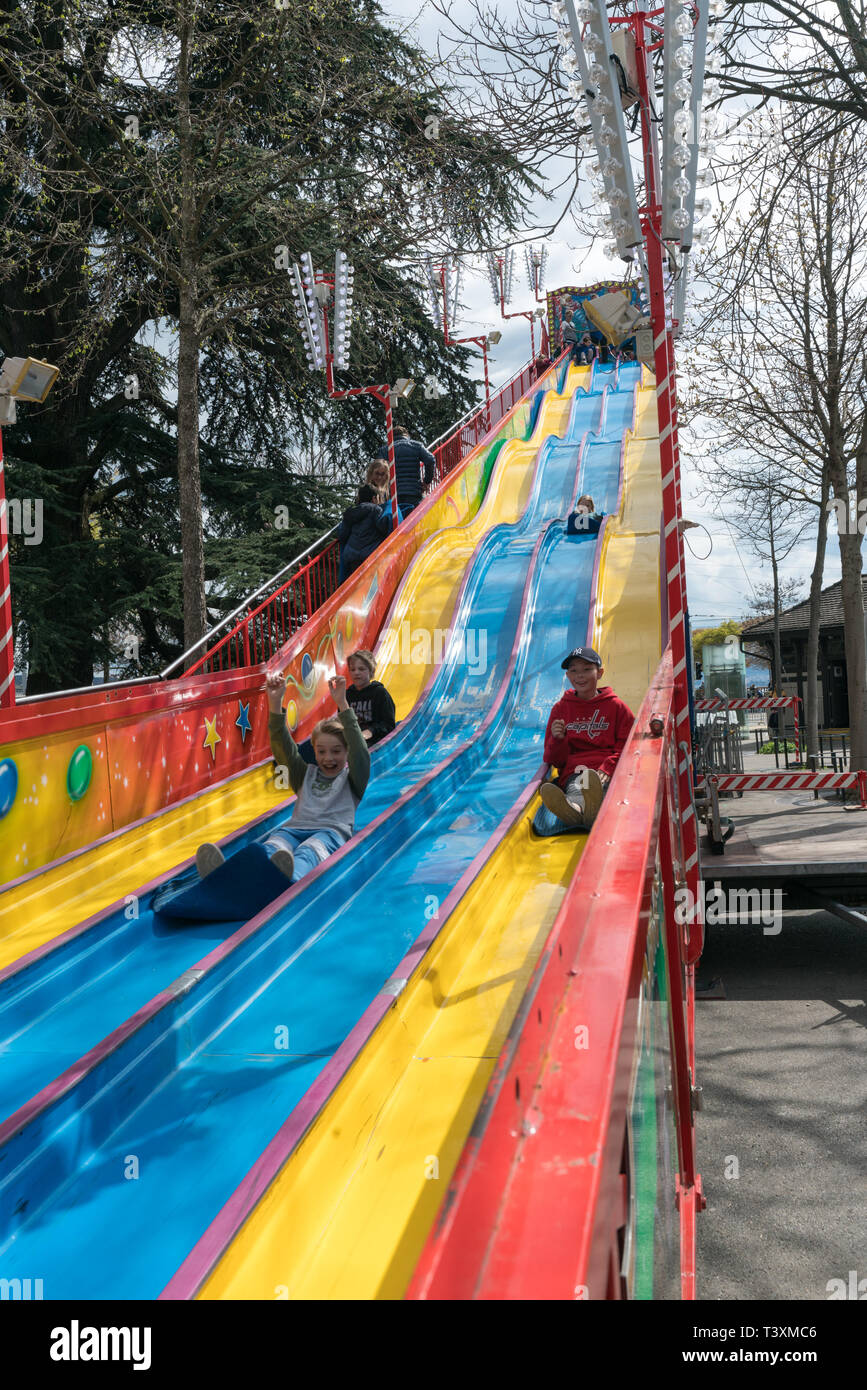 Zurich, ZH / Switzerland - April 8, 2019: people gathering at the Sechselauten spring festival in Zurich and enjoying the amusement park rides and att Stock Photo