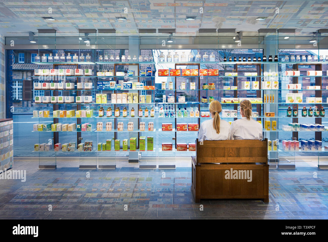 Pharmacists sitting in modern pharmacy Stock Photo