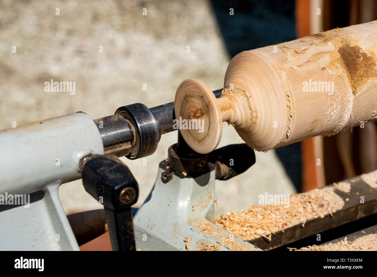 Carving a banister pillar in wood-turning lathe Stock Photo